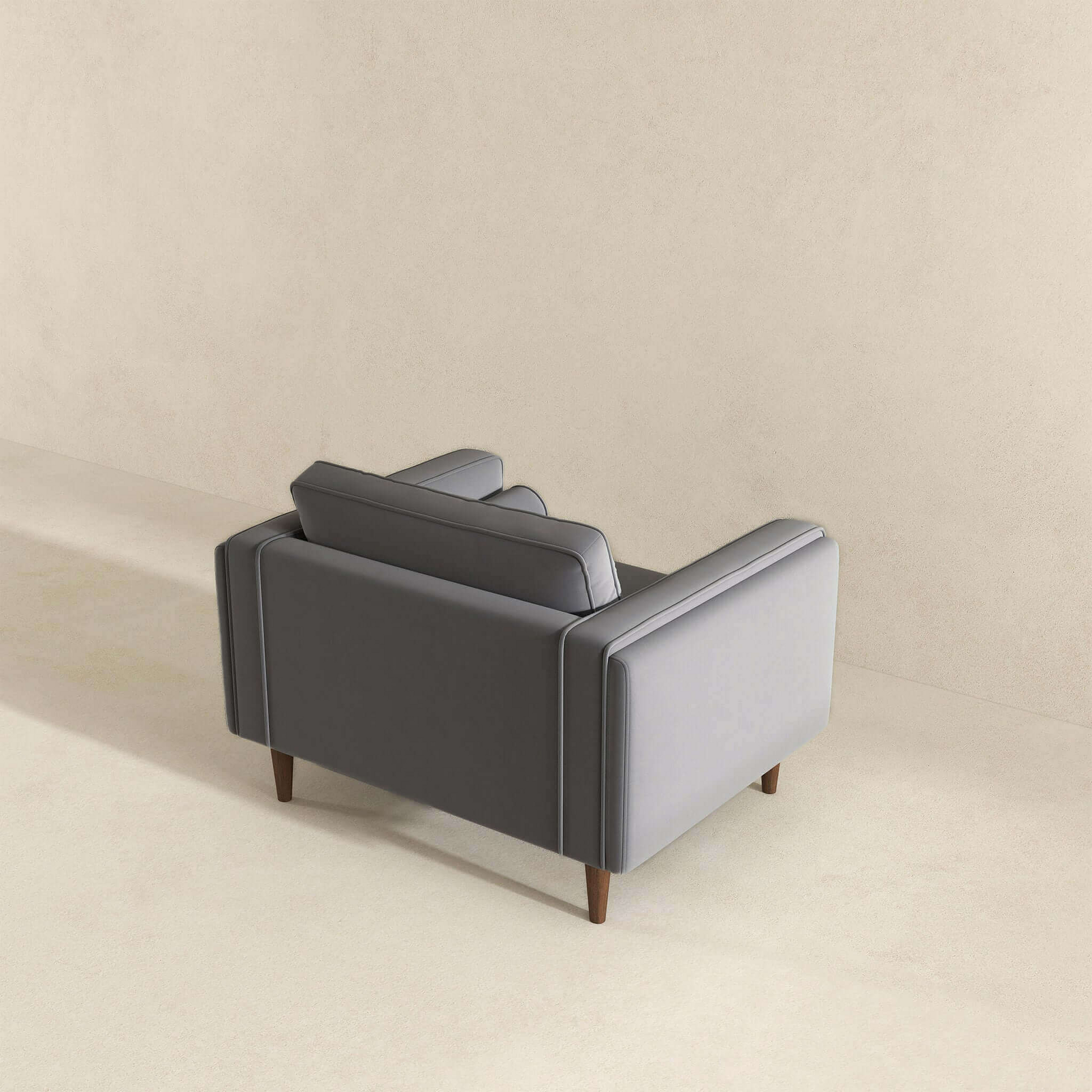 Modern grey velvet armchair with wooden legs perfect for living rooms