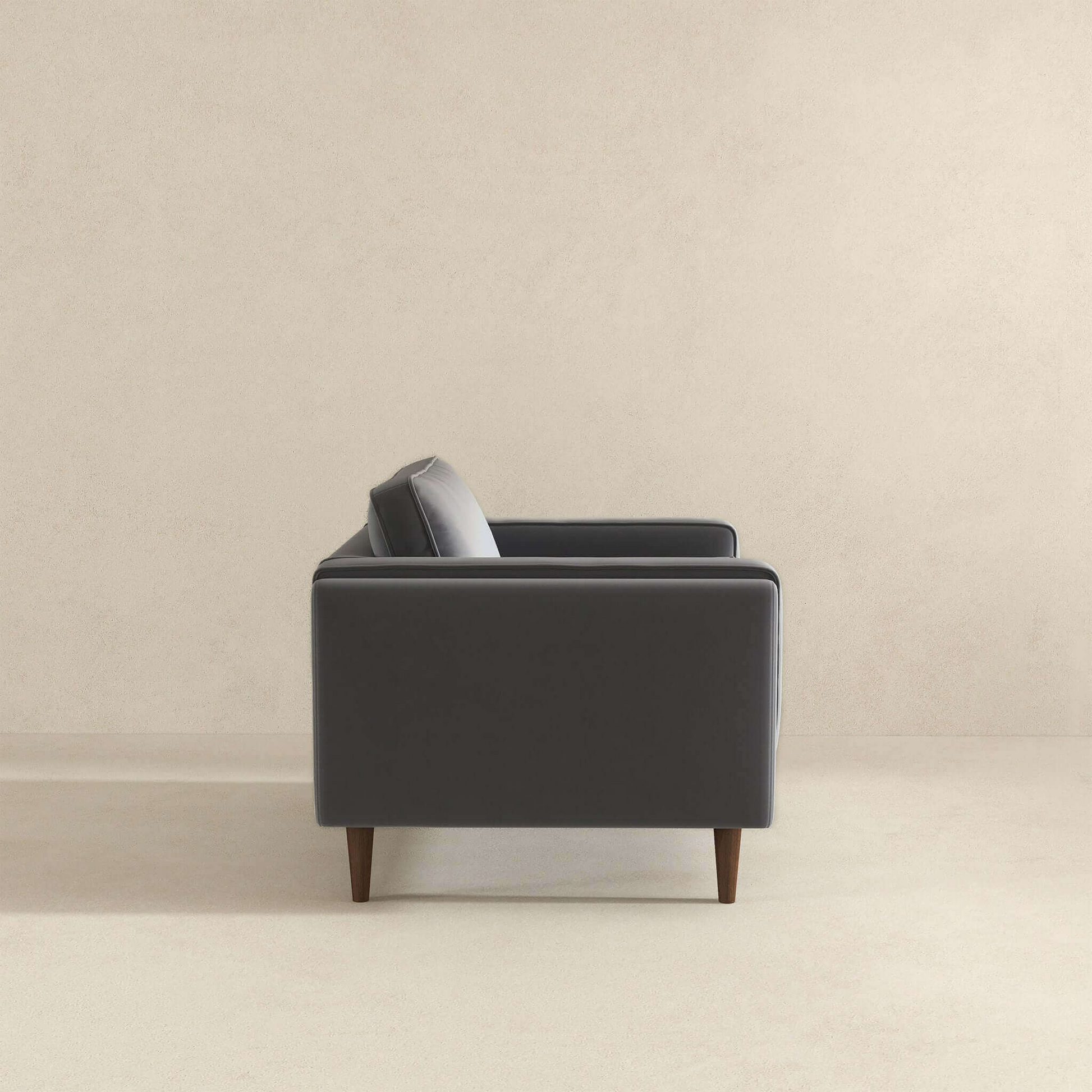 Dark gray modern velvet sofa with tapered wooden legs a stylish addition to any living room