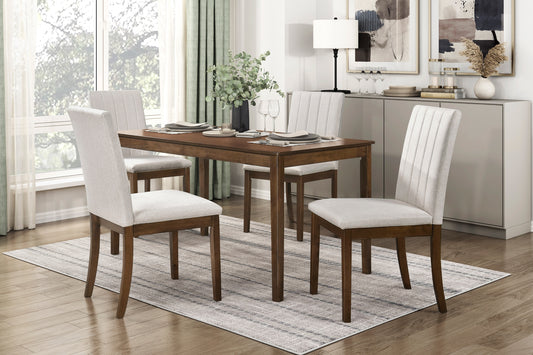 Wooden dining table with four light grey upholstered chairs and a patterned rug