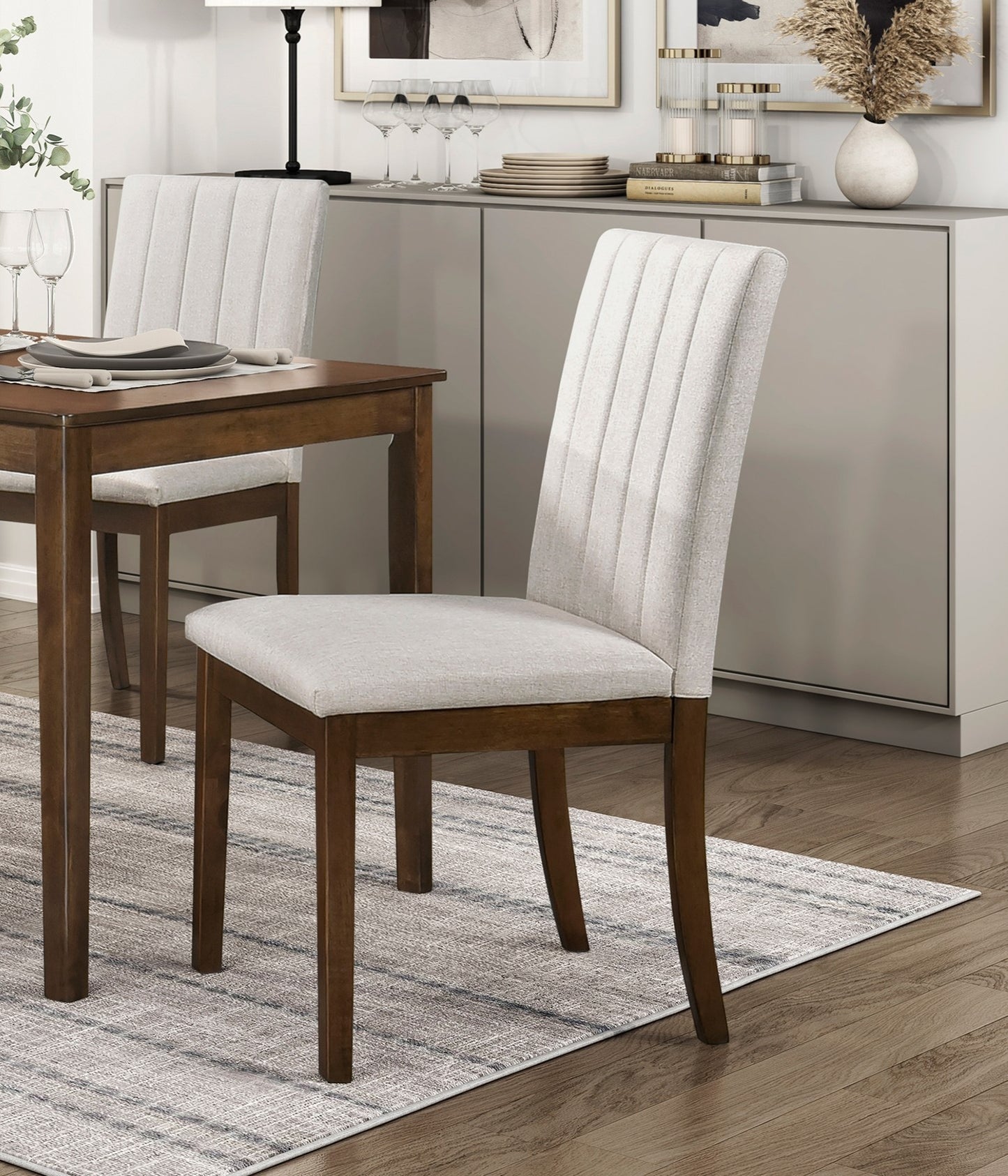 Upholstered dining chair with padded cream seat and vertical stitch detailing on back