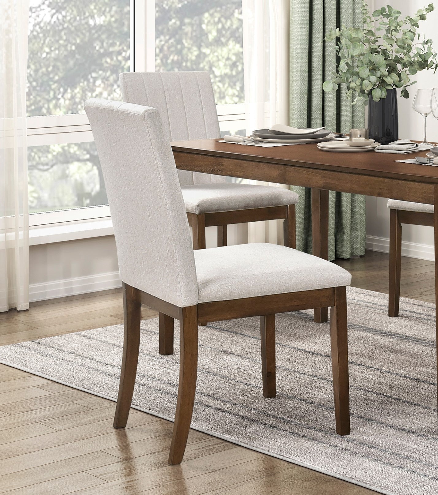 Light grey upholstered dining chairs with wooden frames around a dark wood table