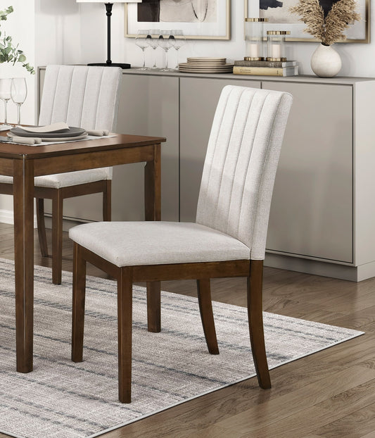 Light grey upholstered dining chair with vertical tufting and dark wood legs perfect for modern dining rooms