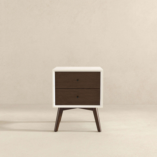 White midcentury modern nightstand with two dark wood drawers and tapered legs