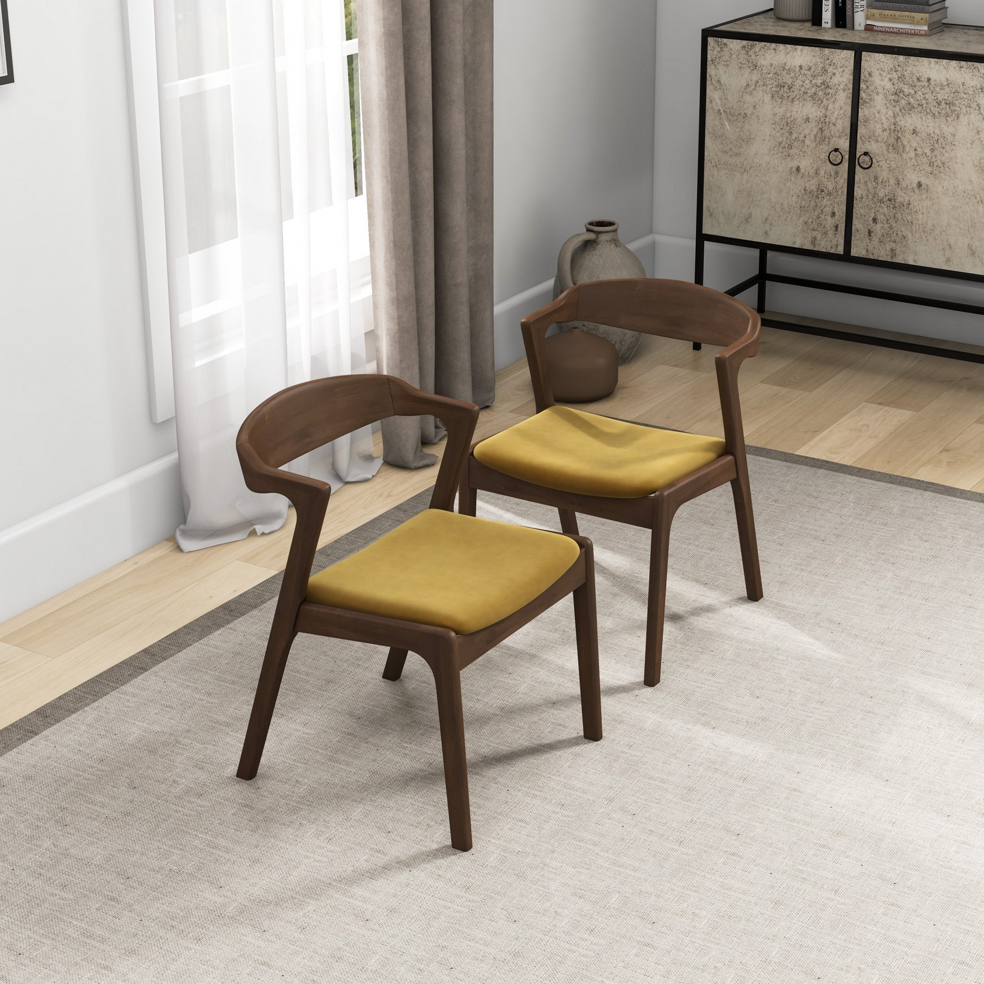 Two modern dark wood chairs with mustard yellow cushions