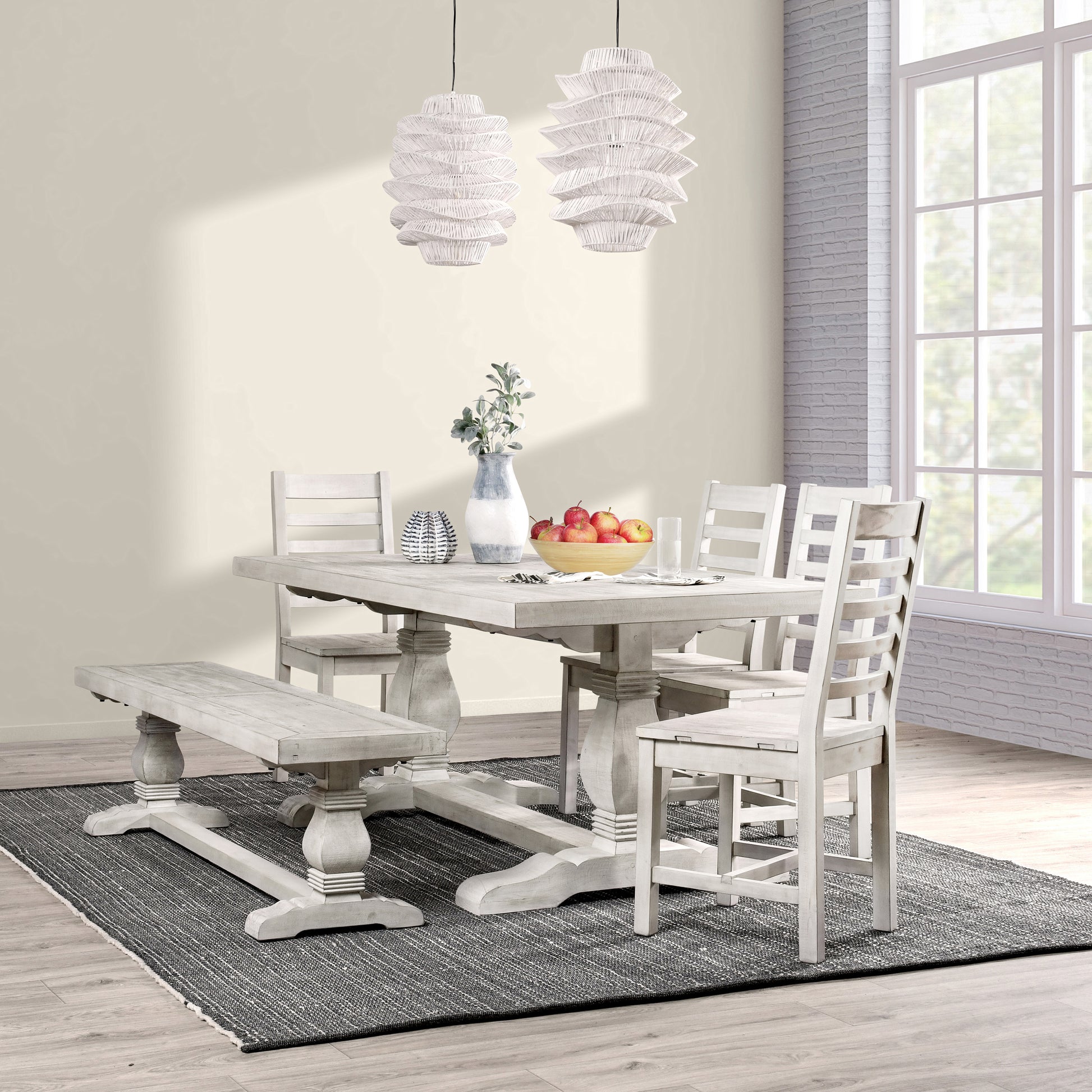 Distressed white farmhouse dining table with matching bench and chairs set for a family meal