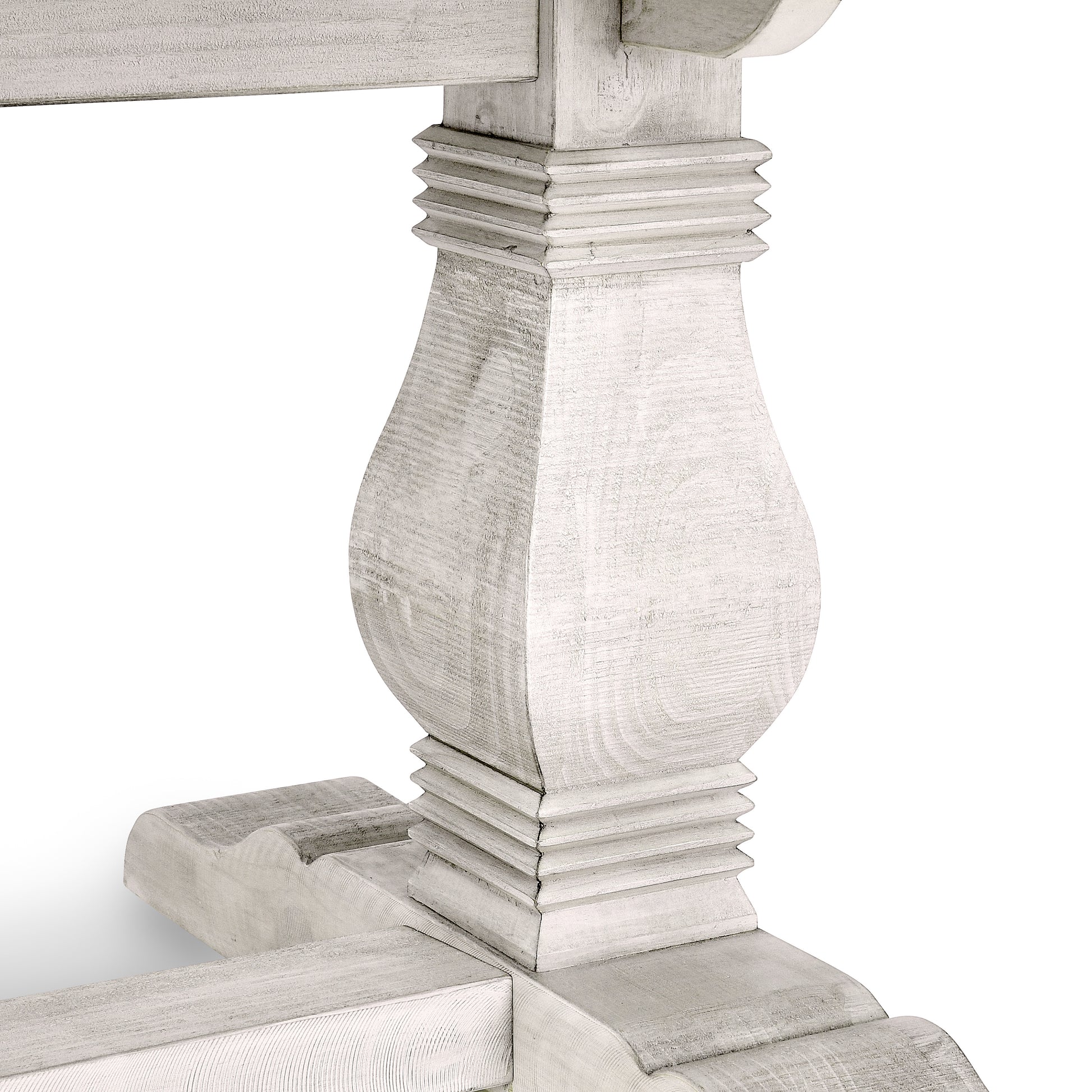 Distressed white wood pedestal base for a dining table featuring carved details