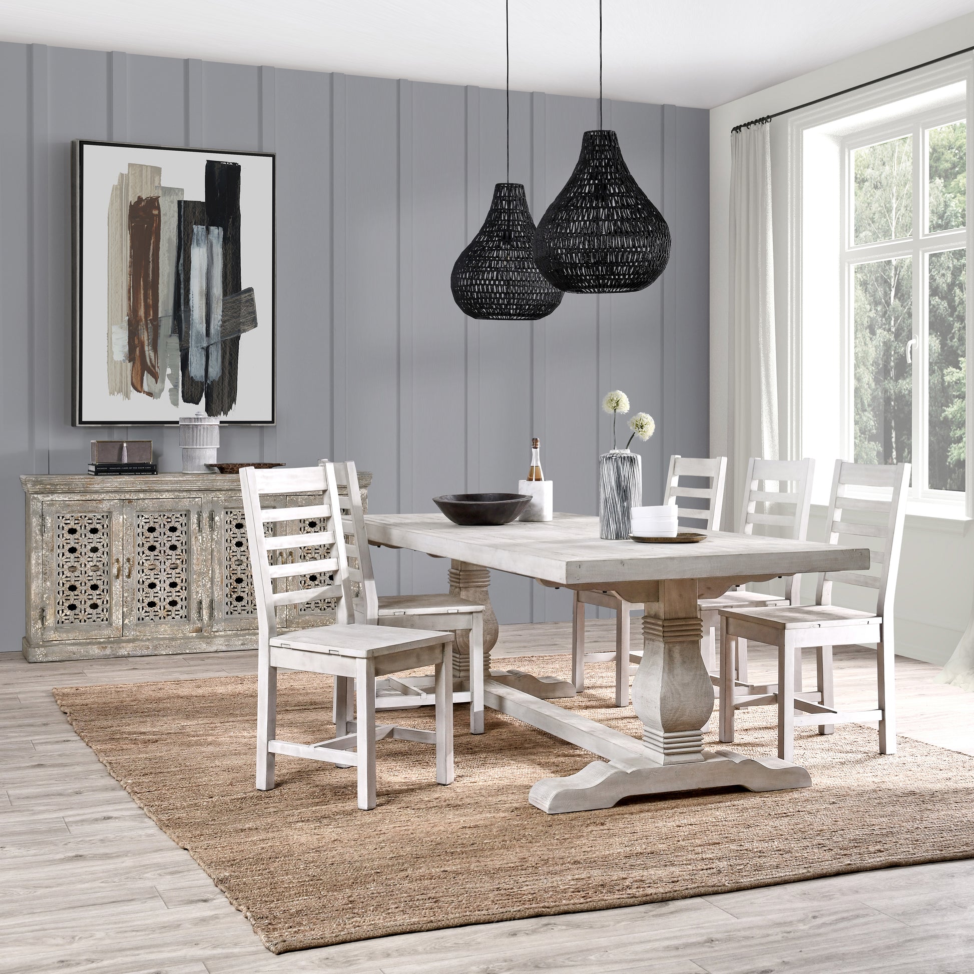 Rustic distressed wood dining table with matching chairs and woven black pendant lights