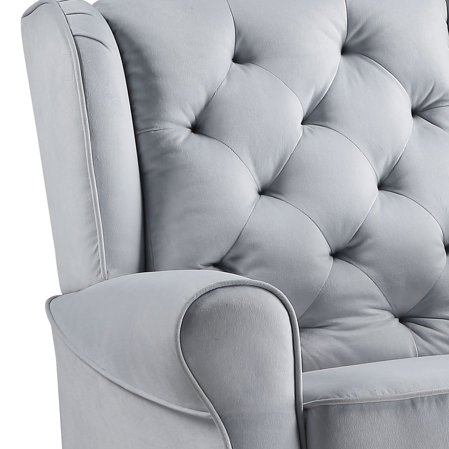 Closeup of a light gray tufted velvet armchairs armrest and back