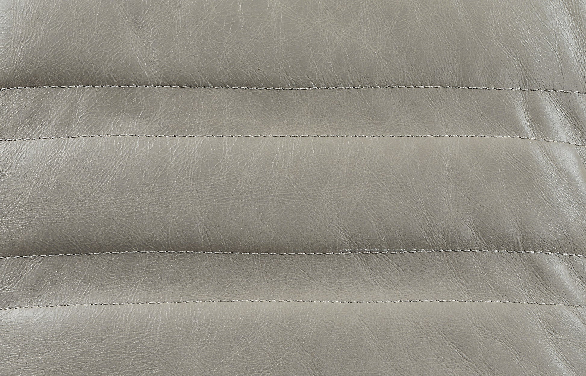 Closeup of grey faux leather texture with parallel stitching ideal for upholstery