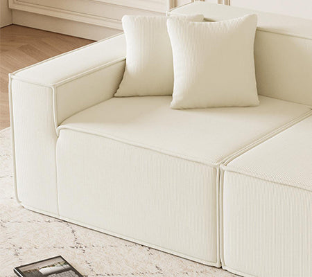 Plush ivory corduroy sectional sofa with matching throw pillows perfect for modern living spaces