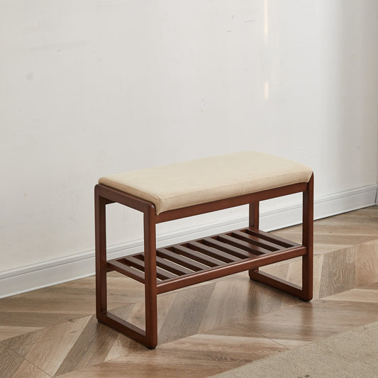 Dark wood entryway bench with cushioned seat and slatted lower shelf for shoe storage