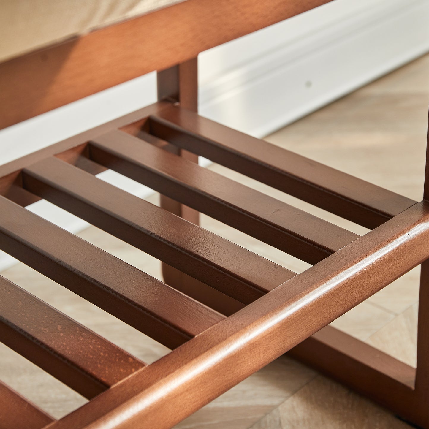 Closeup of dark brown wooden shelf with slatted design for shoe rack storage