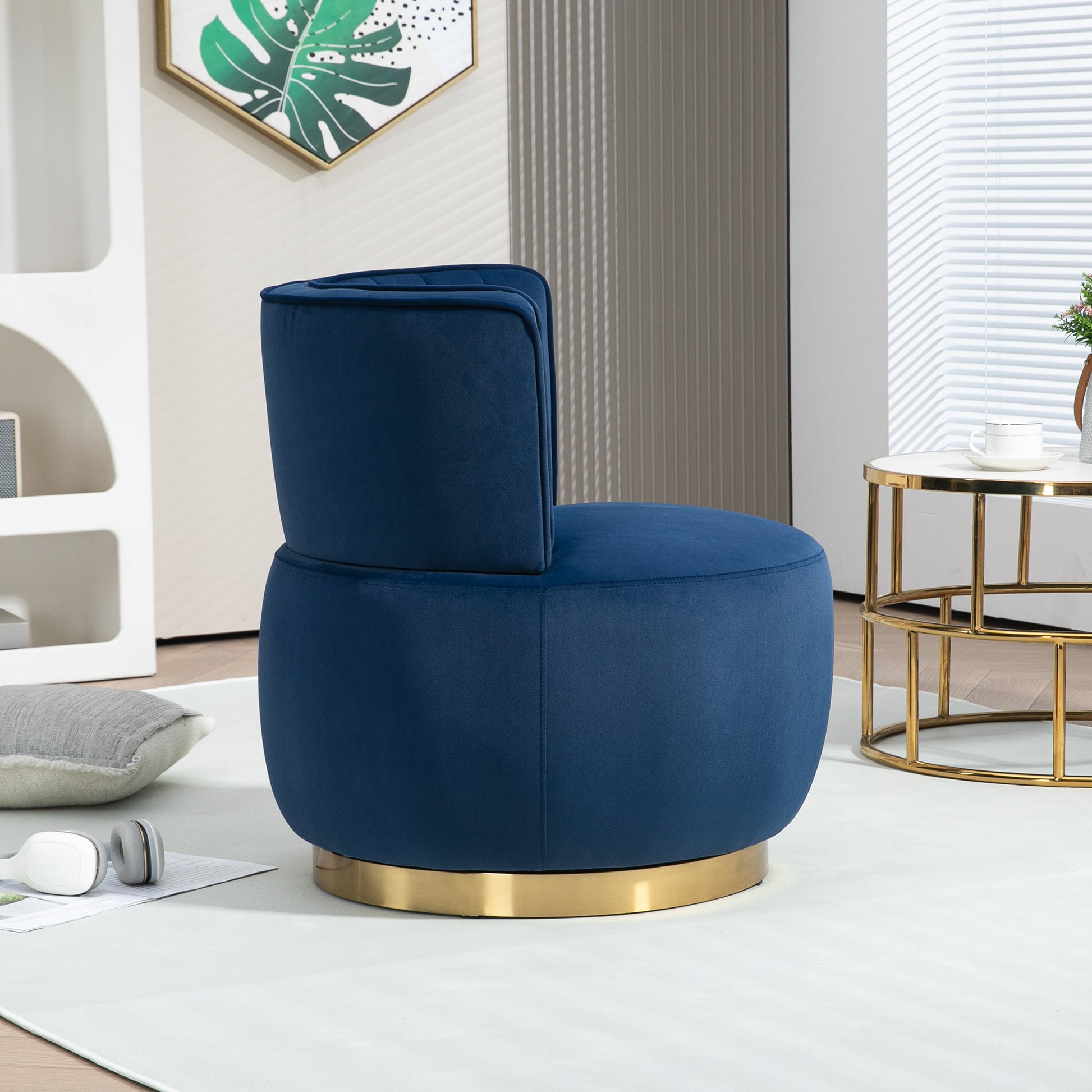 Plush navy blue velvet accent chair with a swivel gold base perfect for modern living rooms