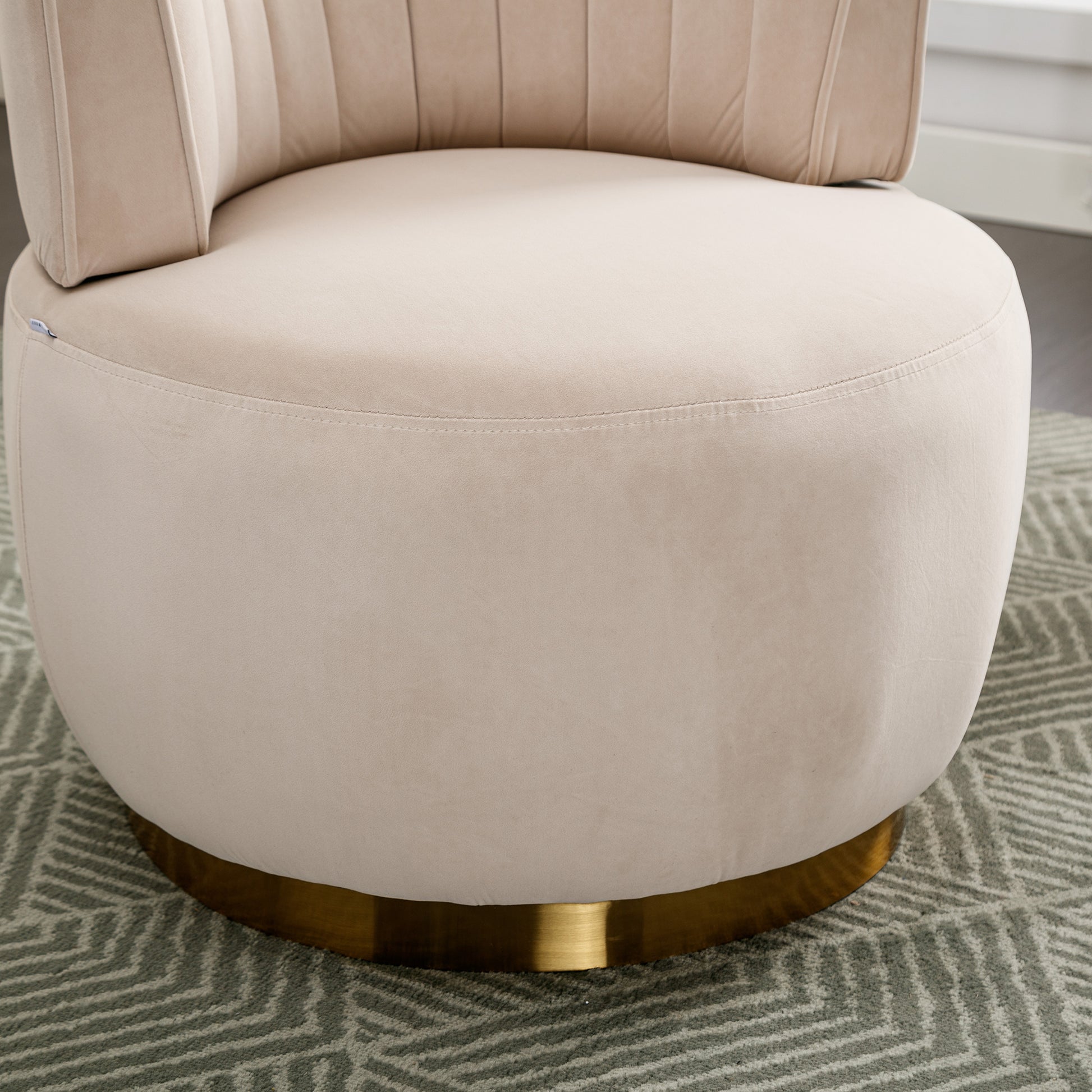 Plush beige velvet accent chair with channel tufting and gold base perfect for modern living rooms