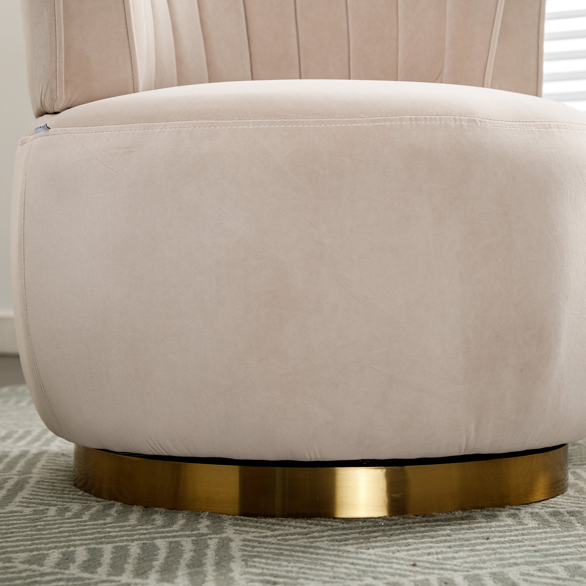 Cream velvet accent chair with plush upholstery and gold swivel base