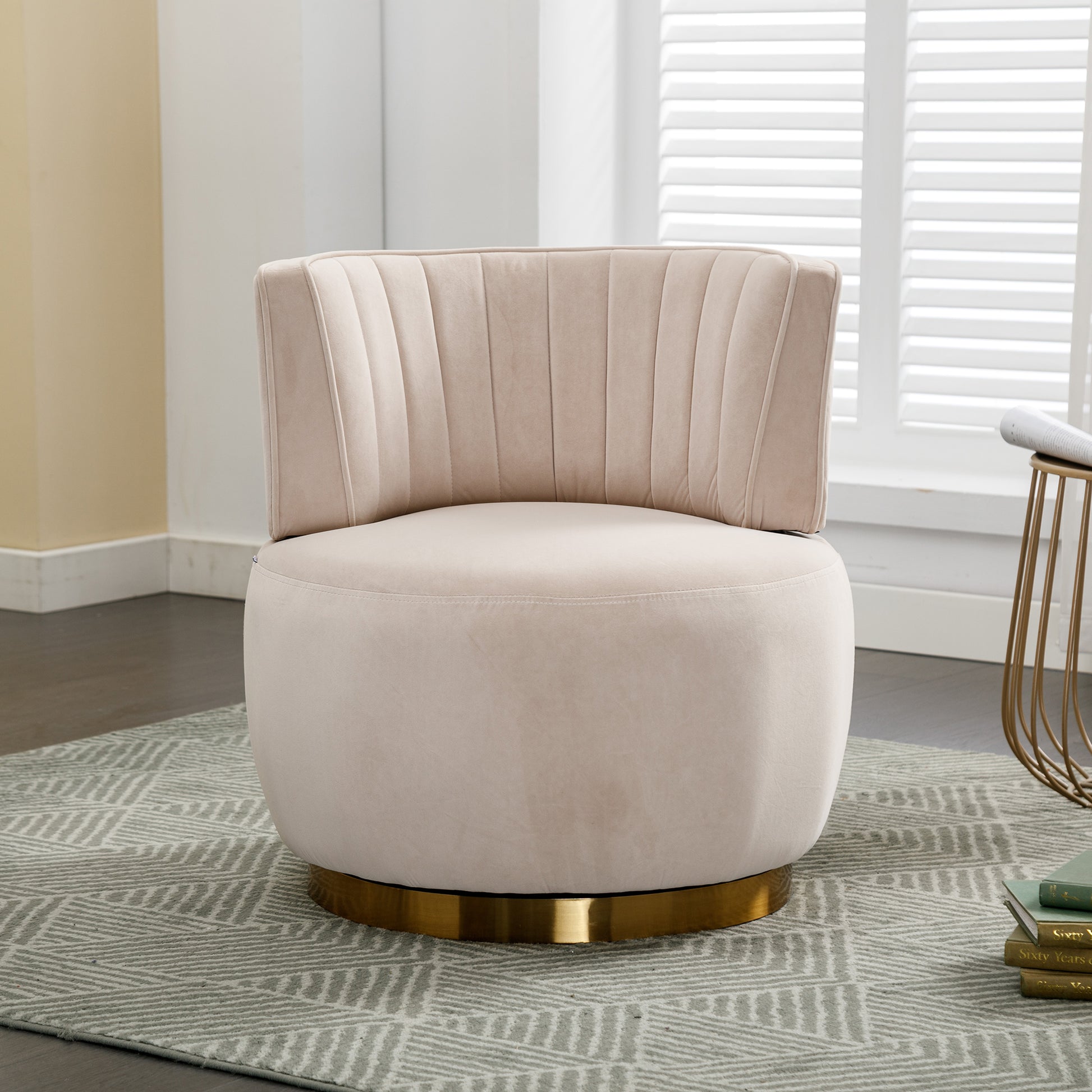 Plush beige velvet accent chair with vertical channel tufting and a polished gold swivel base