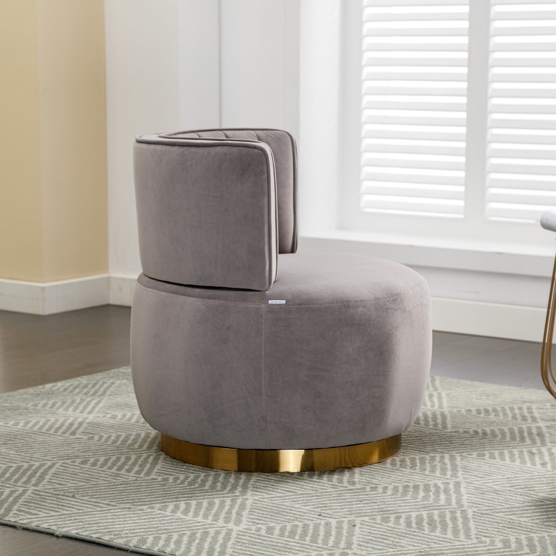 Plush grey velvet accent chair with gold swivel base and tufted back