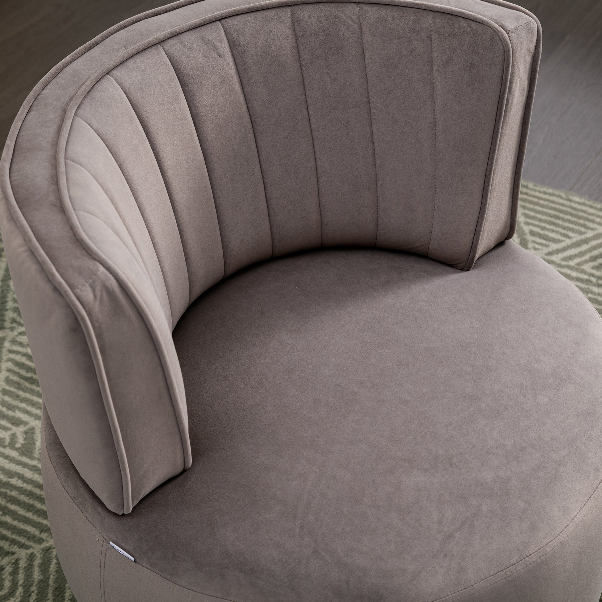 Plush grey velvet accent chair with vertical channel tufting on the backrest
