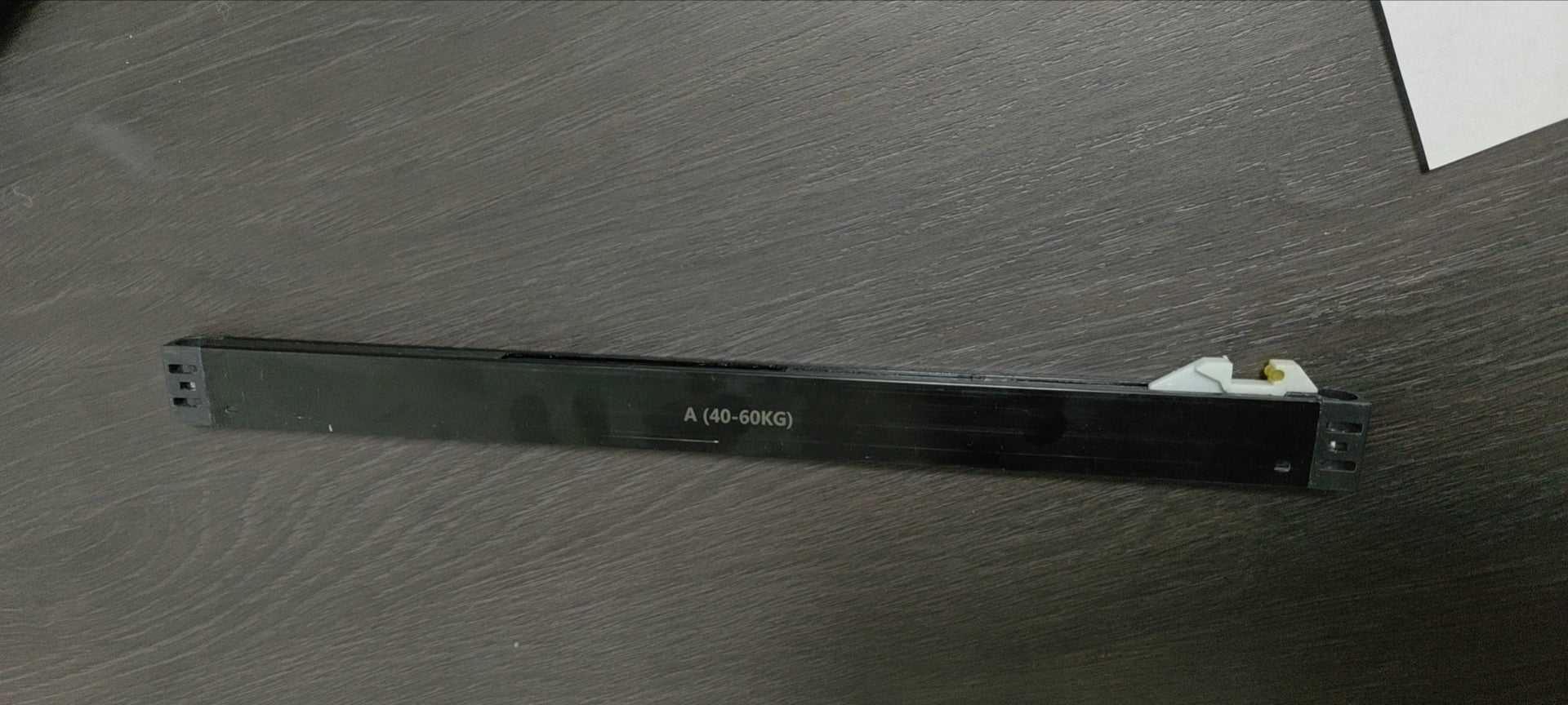Black cabinet drawer slide with A KG label