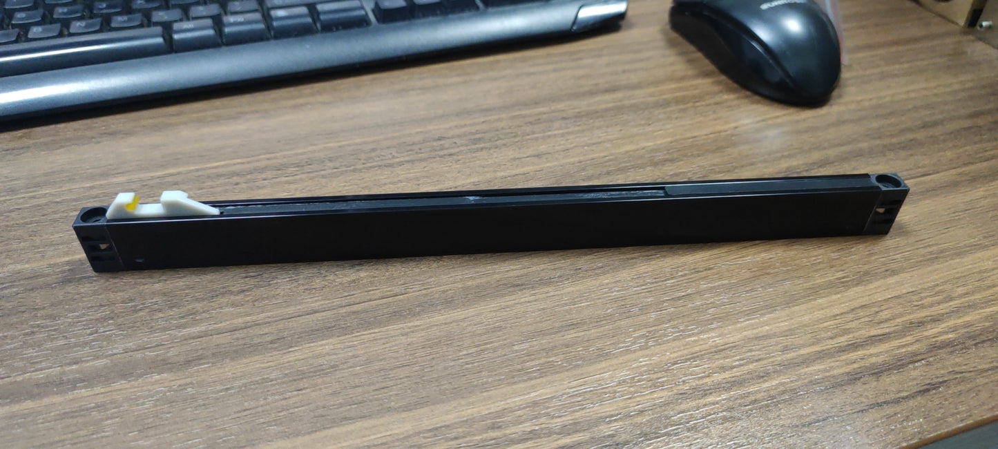 Black linear drawer slide with white and yellow plastic retention clips for cabinet installation