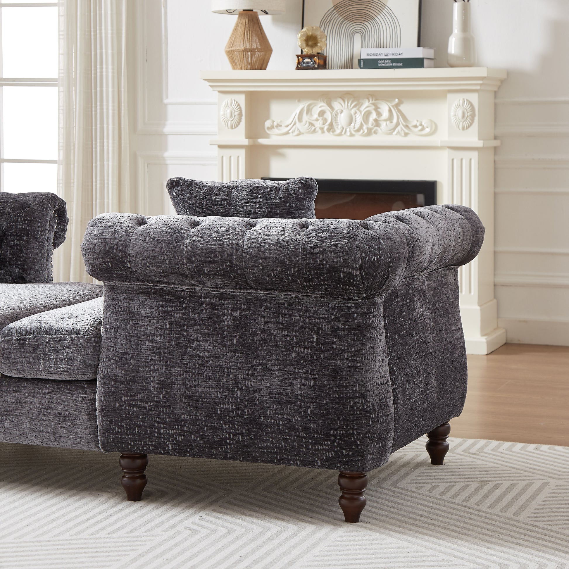 Dark grey velvet chesterfield sofa with button tufting and plush cushions