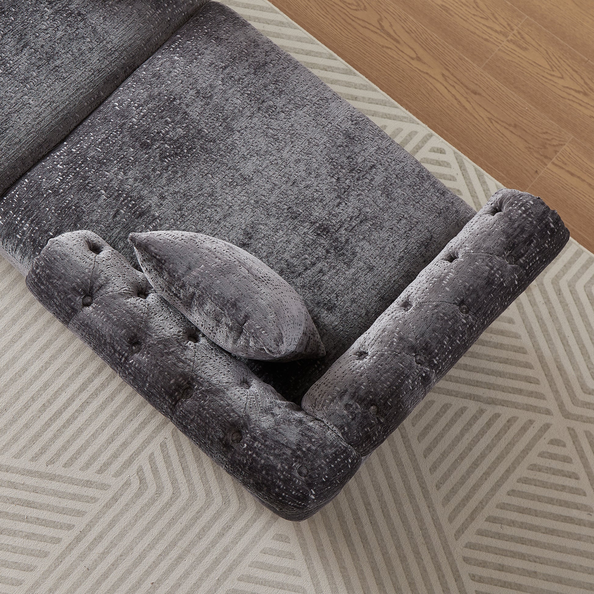 Dark grey tufted velvet sofa armrest and cushion with textured fabric