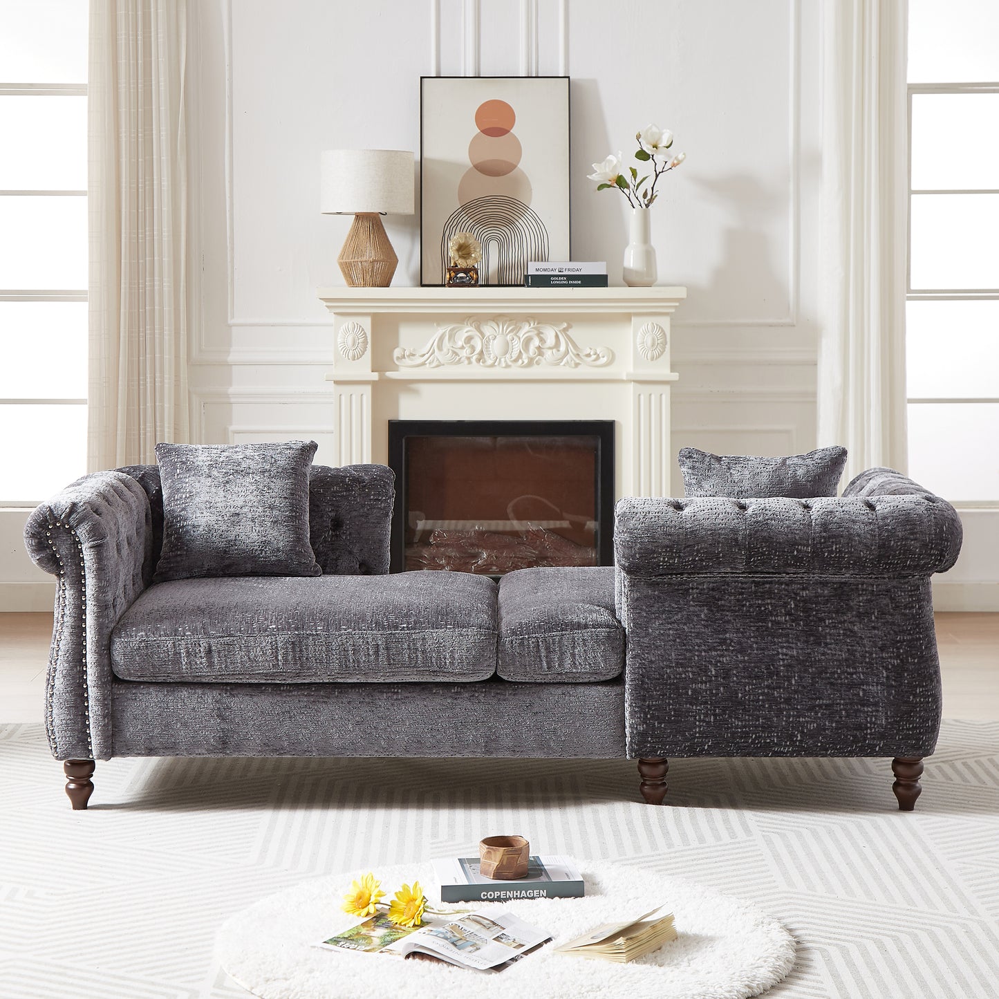 Plush grey velvet chesterfield sofa with button tufting and silver nailhead trim