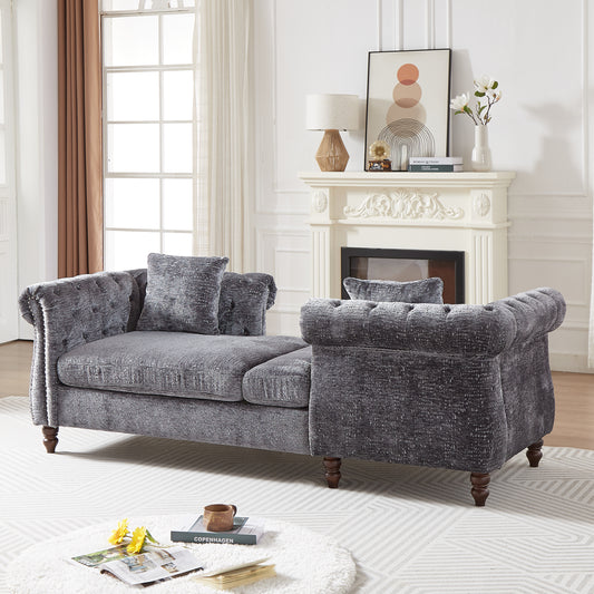 Tufted charcoal velvet sofa with ornate carved wooden legs perfect for living rooms