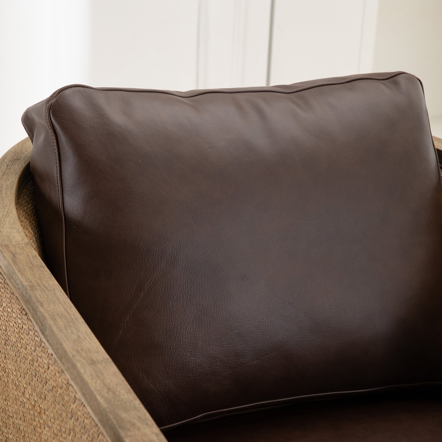 Dark brown leather armchair cushion with textured woven side details