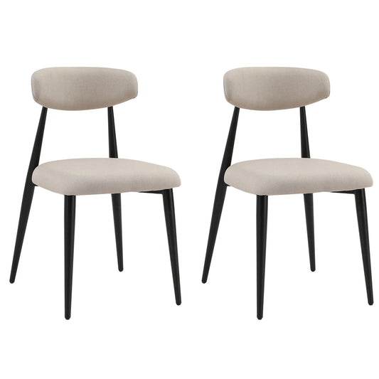 Two upholstered dining chairs in light beige with tapered black legs