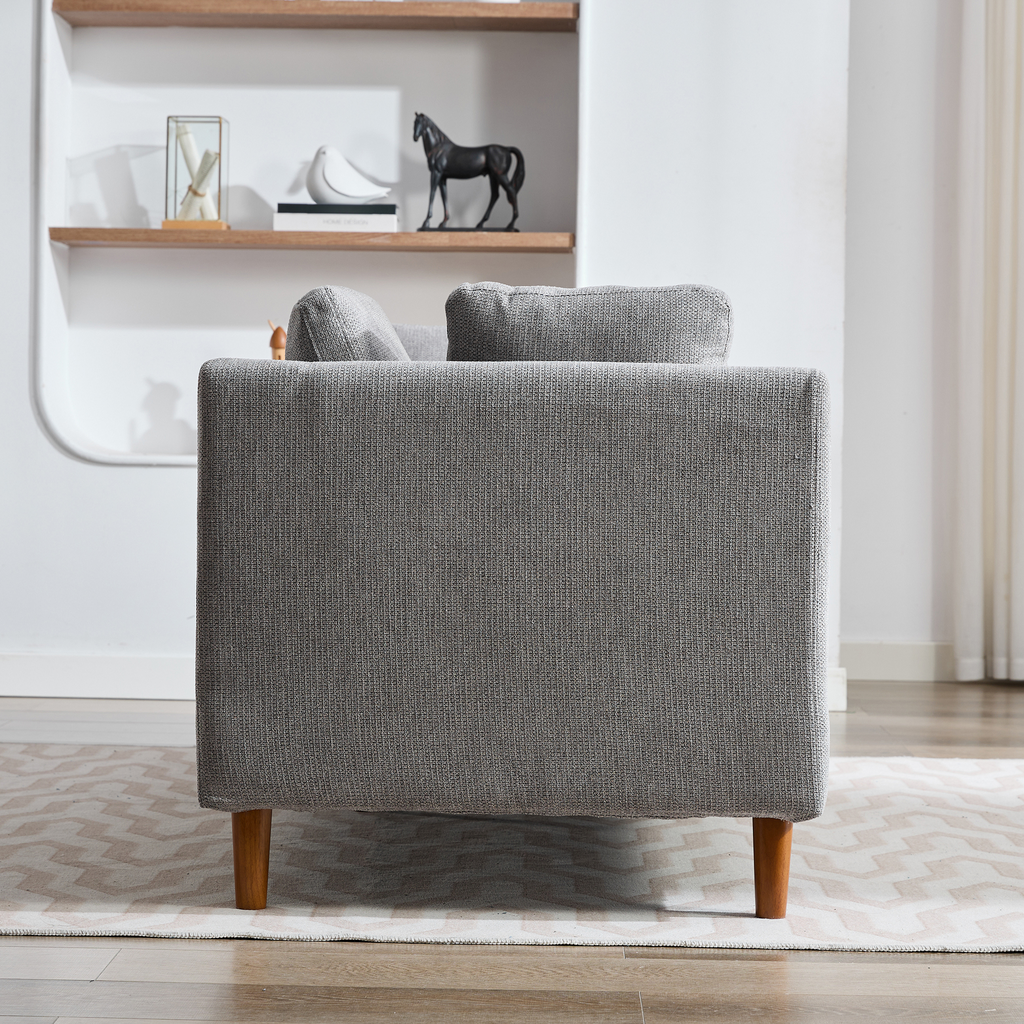 Gray fabric sofa with natural wood legs and plush cushions