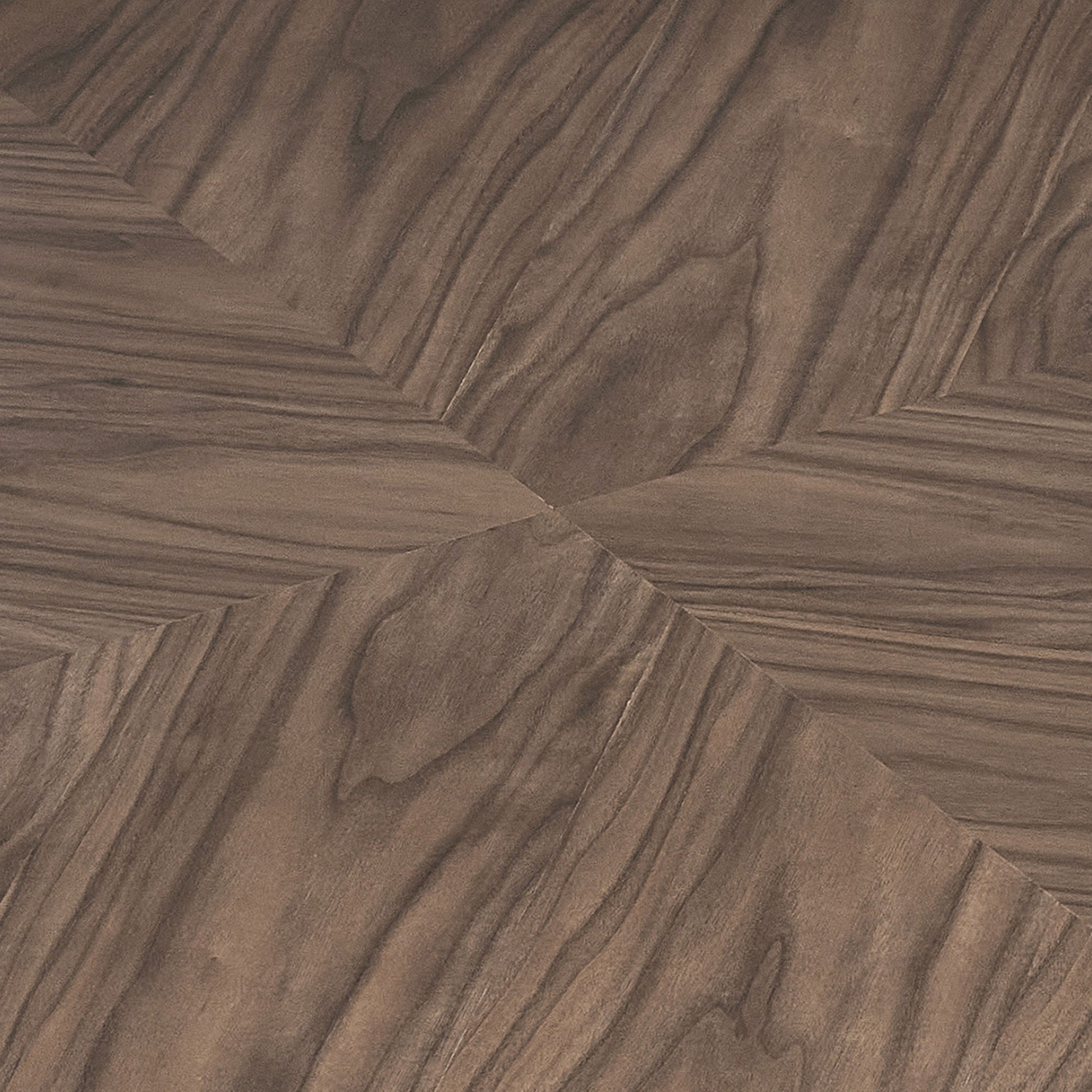 Closeup of dark walnut wood flooring in a chevron pattern showcasing natural grain