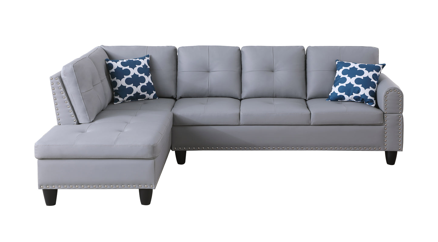 Gray faux leather sectional sofa with tufted cushions and decorative nailhead trim ideal for living rooms