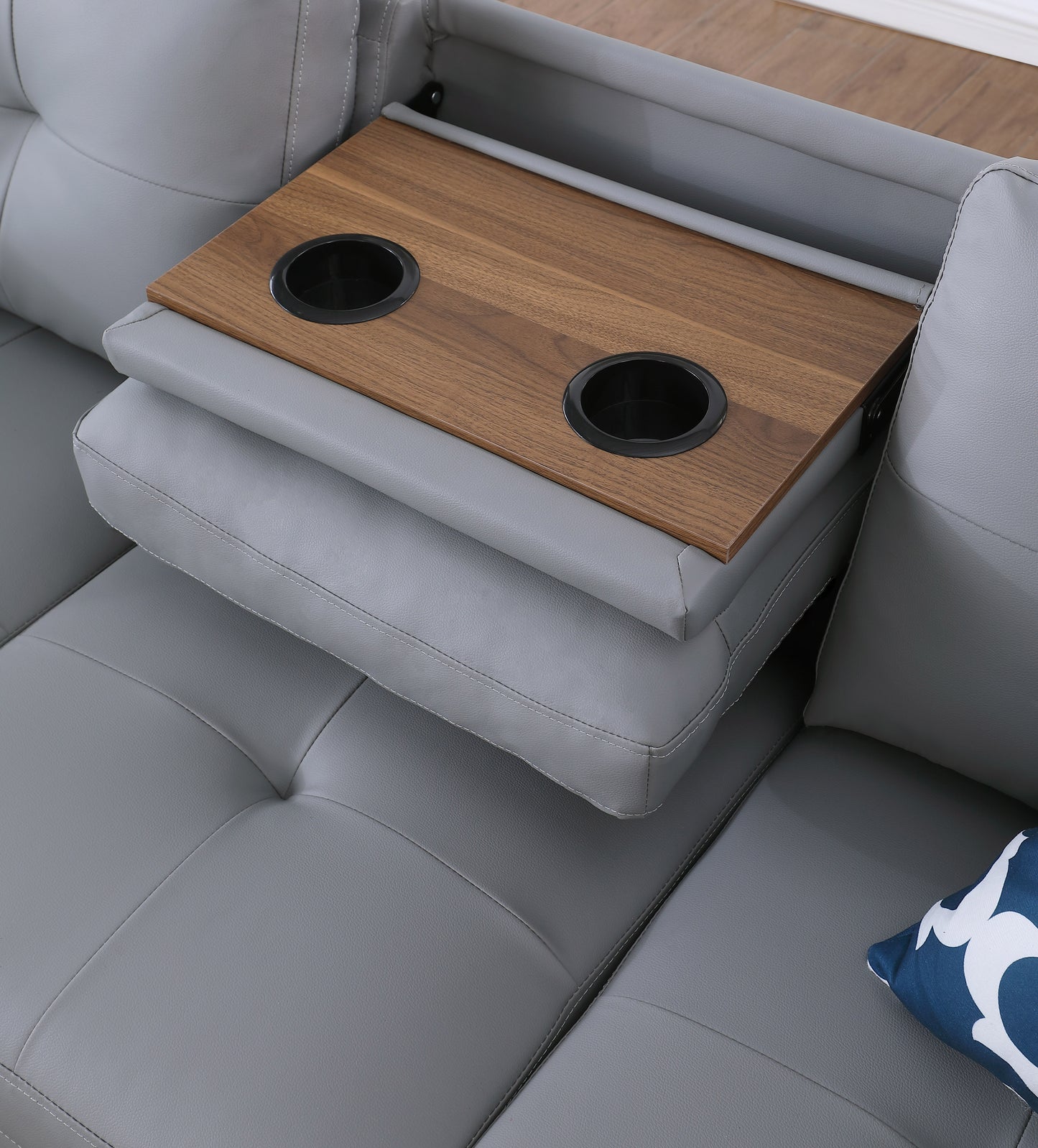 Gray faux leather sectional sofa with builtin wooden tray and cup holders for movie nights