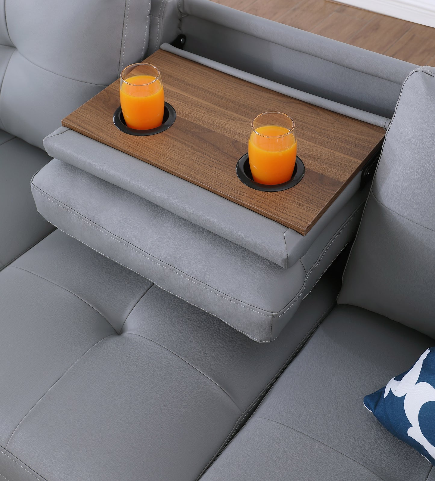 Grey leather sofa with builtin wooden tray and drinks