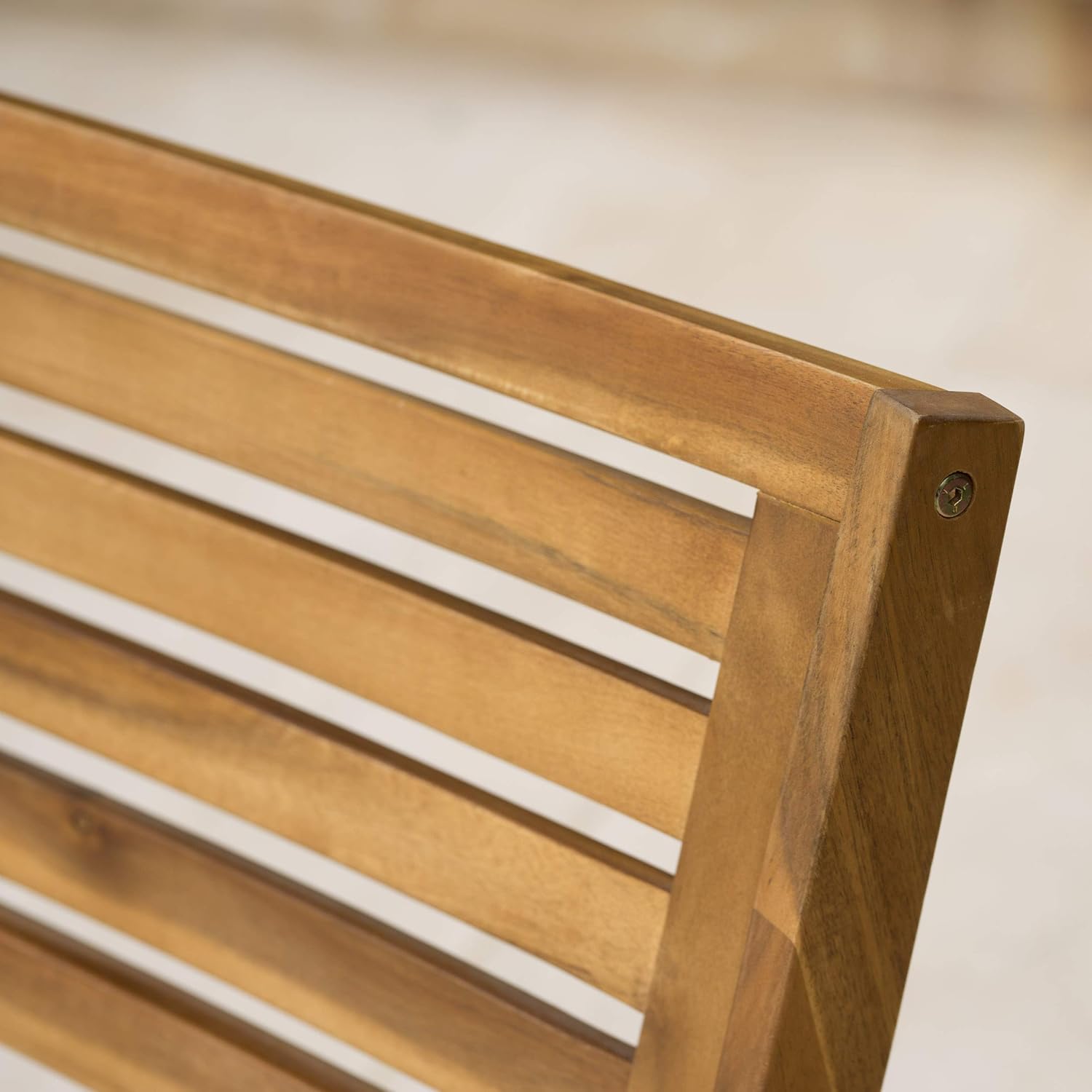 Closeup of a natural wood outdoor bench slatted backrest detail