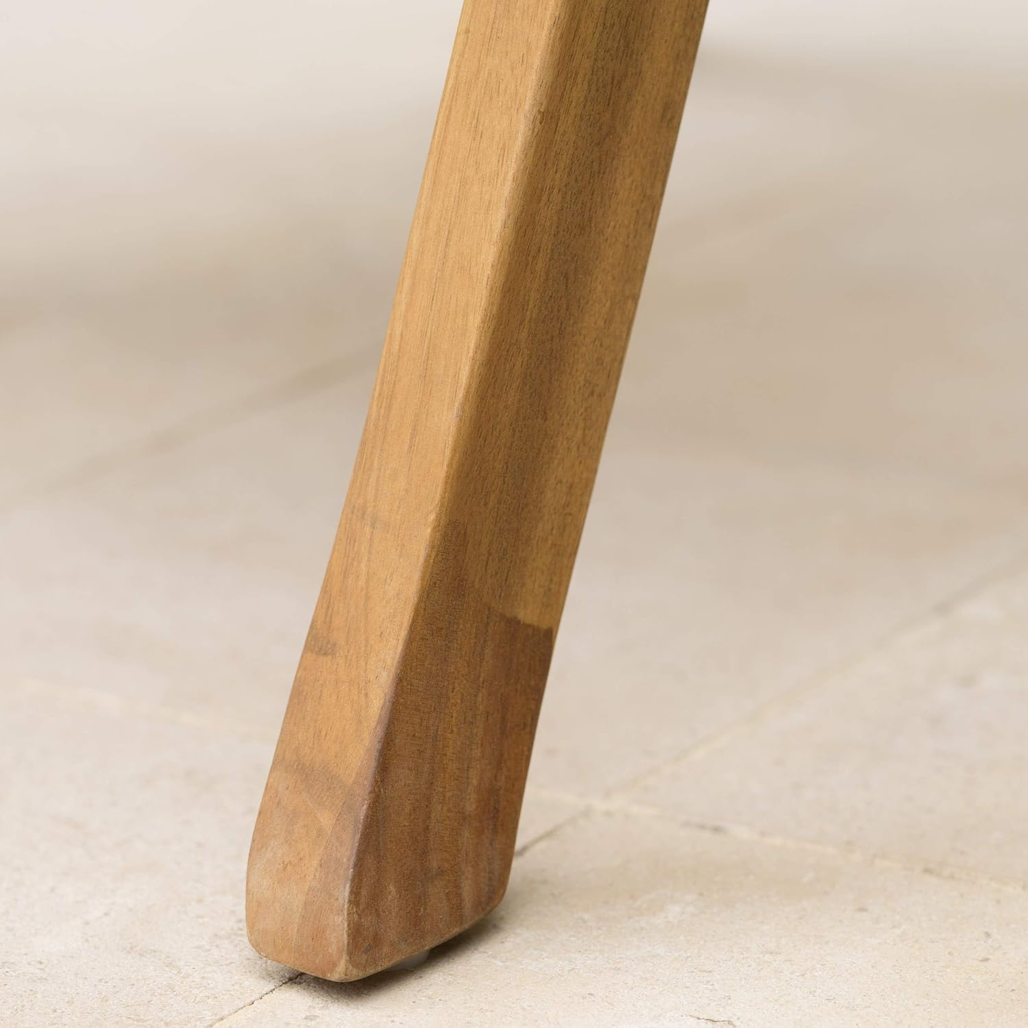 Closeup of a natural wood table leg with a tapered base
