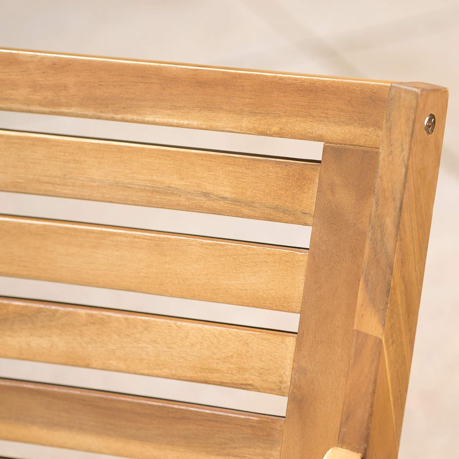 Close up of natural wood slats on a patio chair back