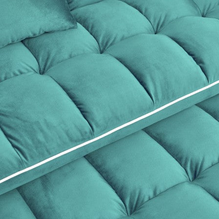 Turquoise velvet tufted headboard with plush cushioning for a luxurious bedroom