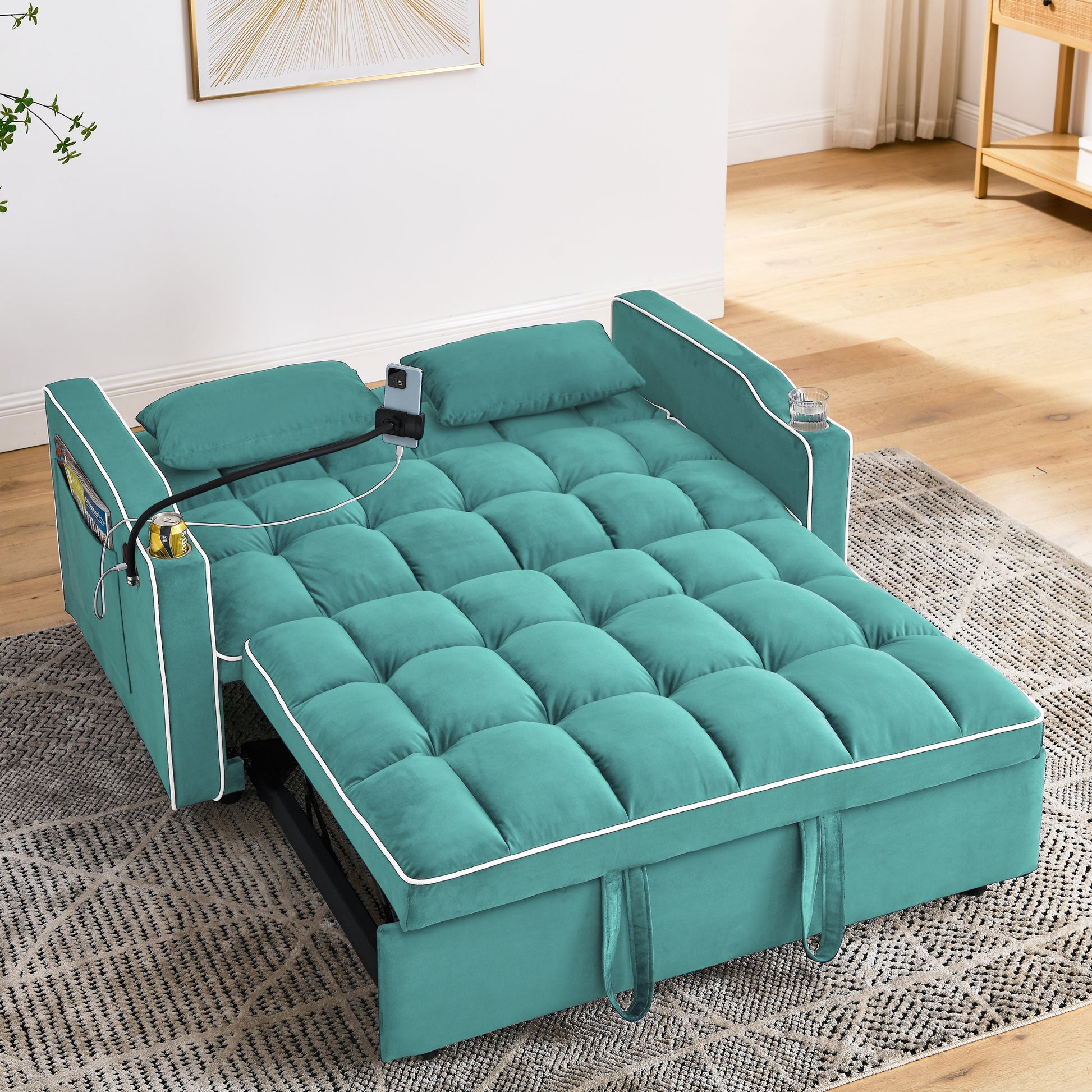 Teal velvet sofa bed with tufted cushions and white piping perfect for small spaces