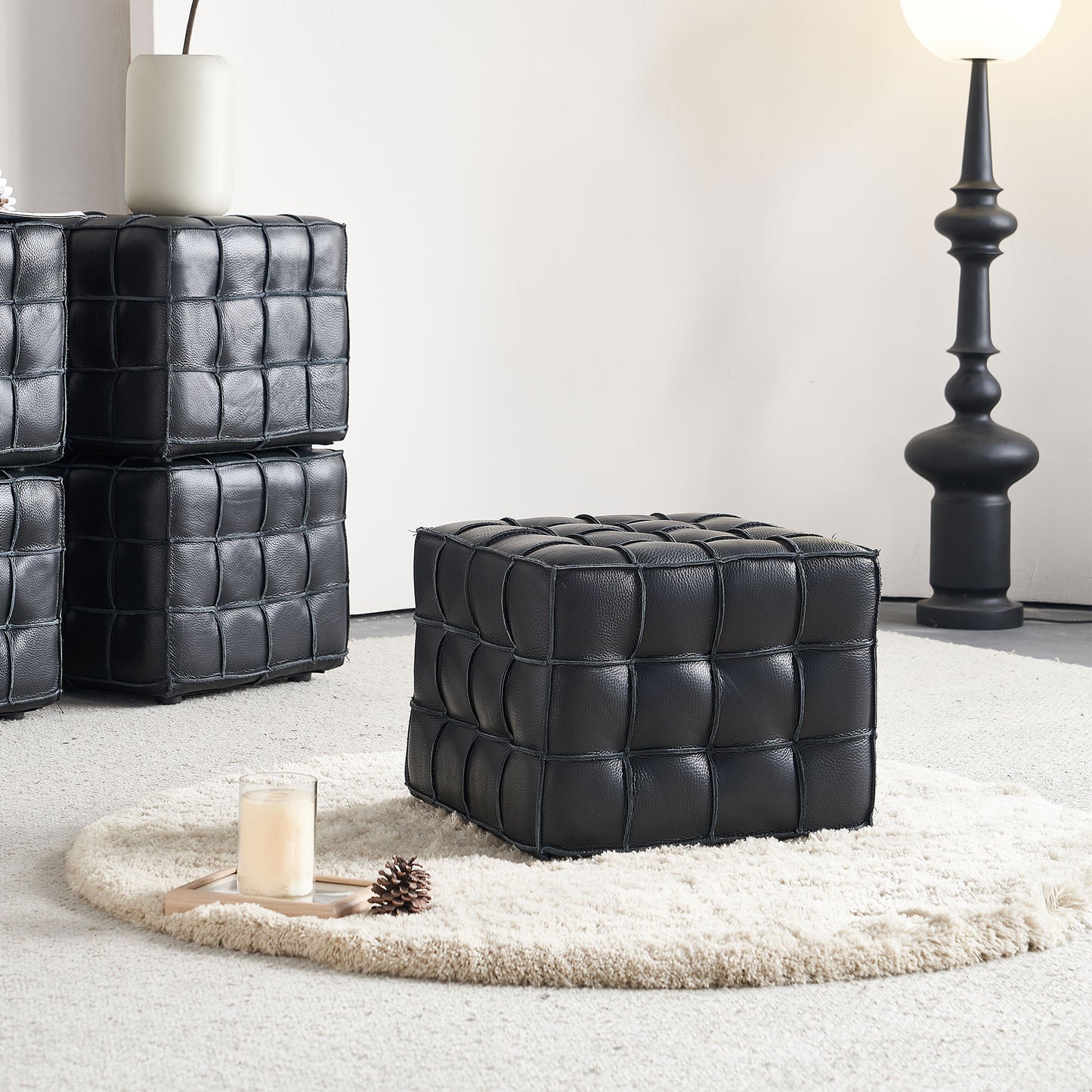 Black leather cube ottoman with tufted design perfect for modern living rooms