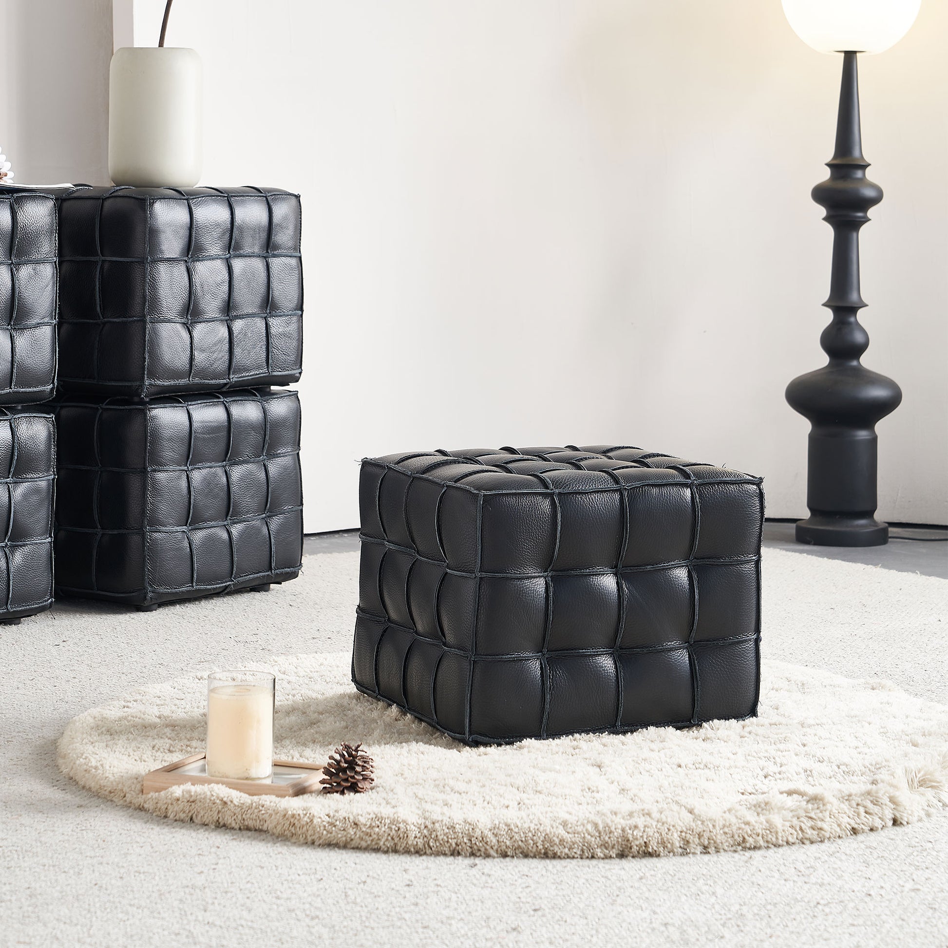 Black leather cube ottoman with tufted design perfect for modern living rooms