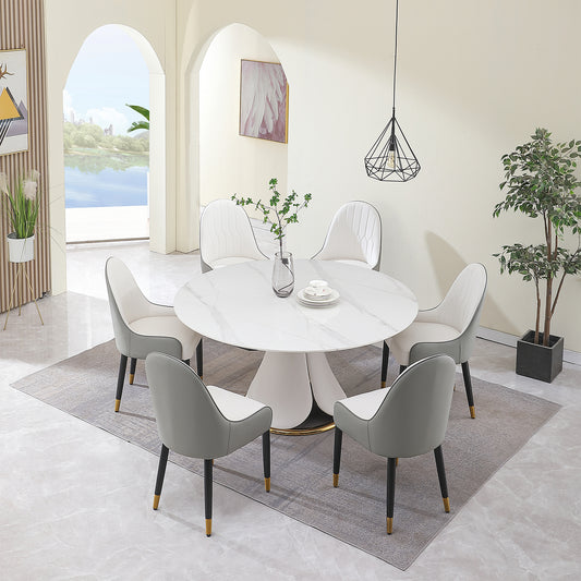 Round marble dining table with five upholstered chairs in grey and white