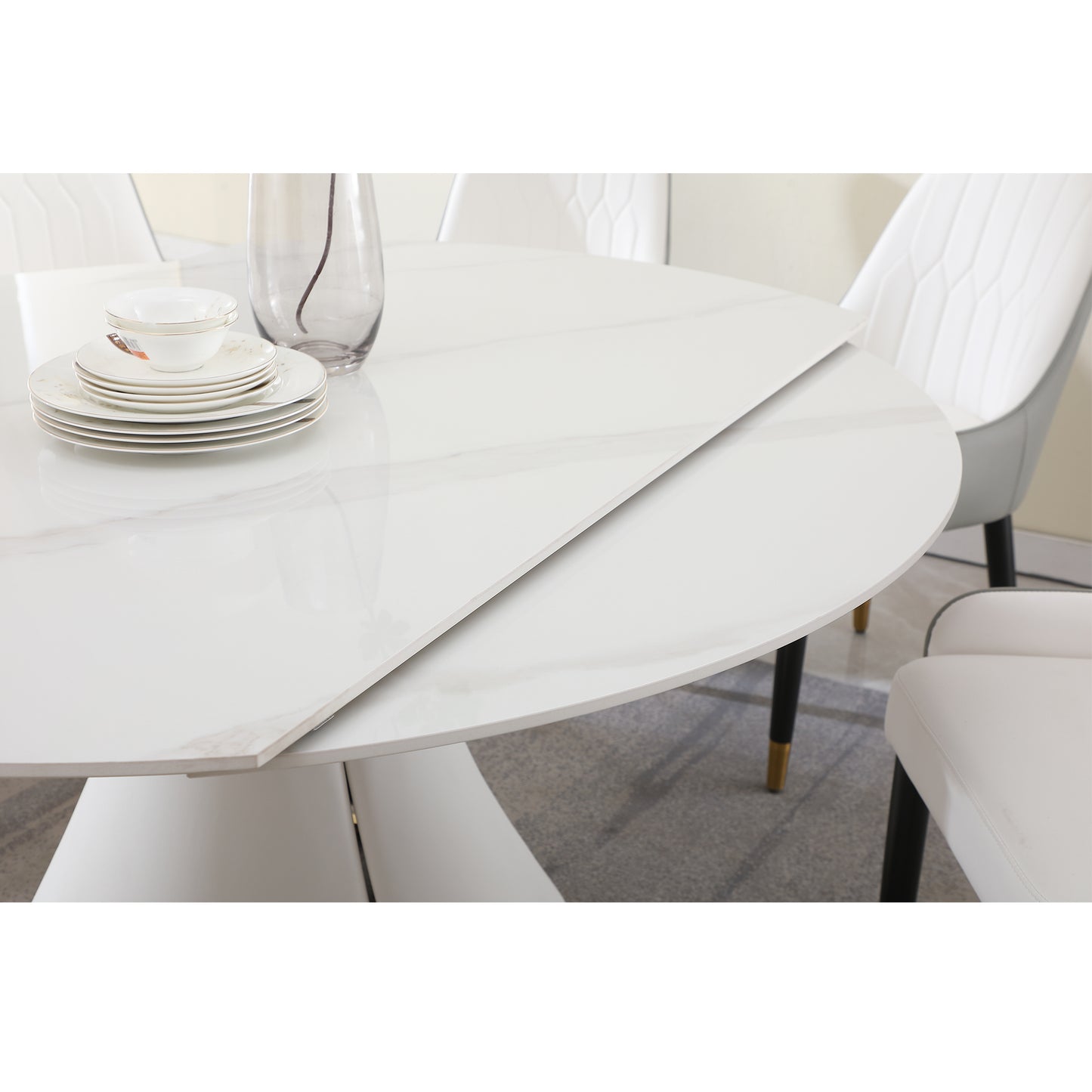 White ceramic dining table with marble veining and extension leaf
