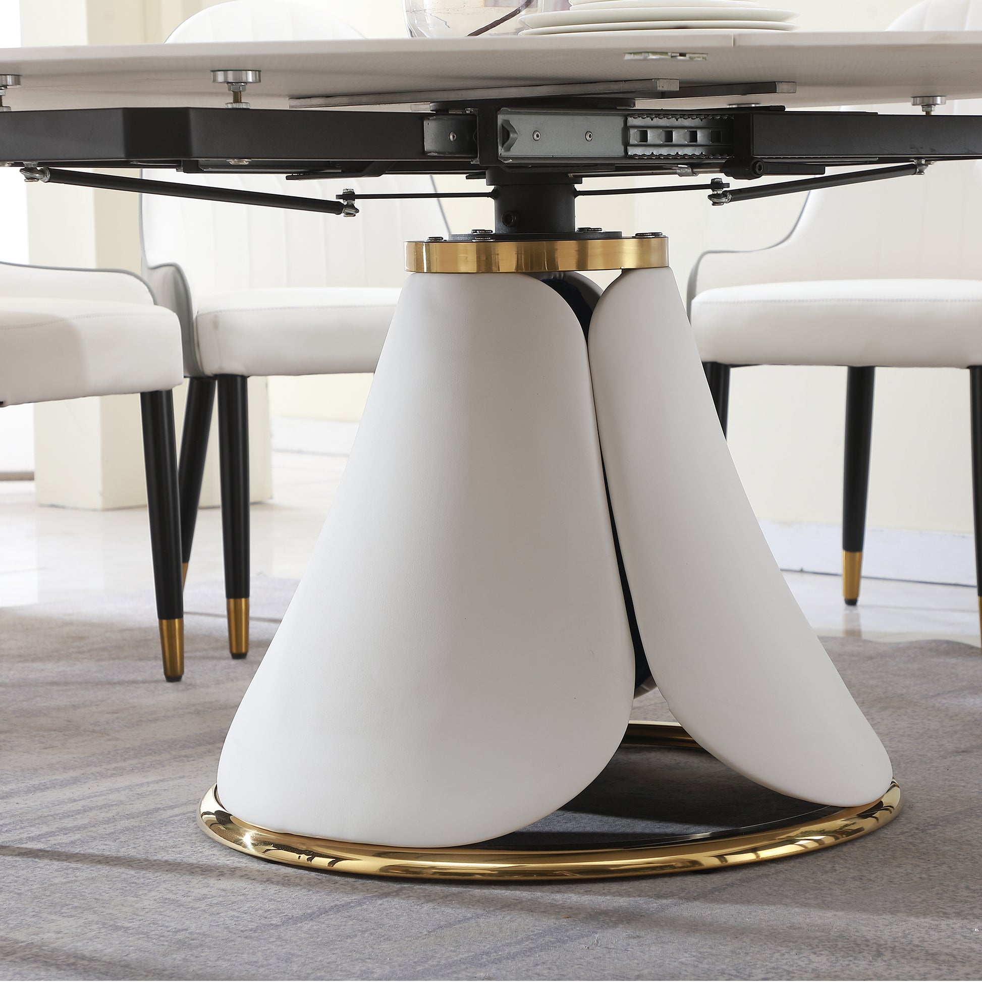 Modern dining table base with sculptural white pedestal and gold accents
