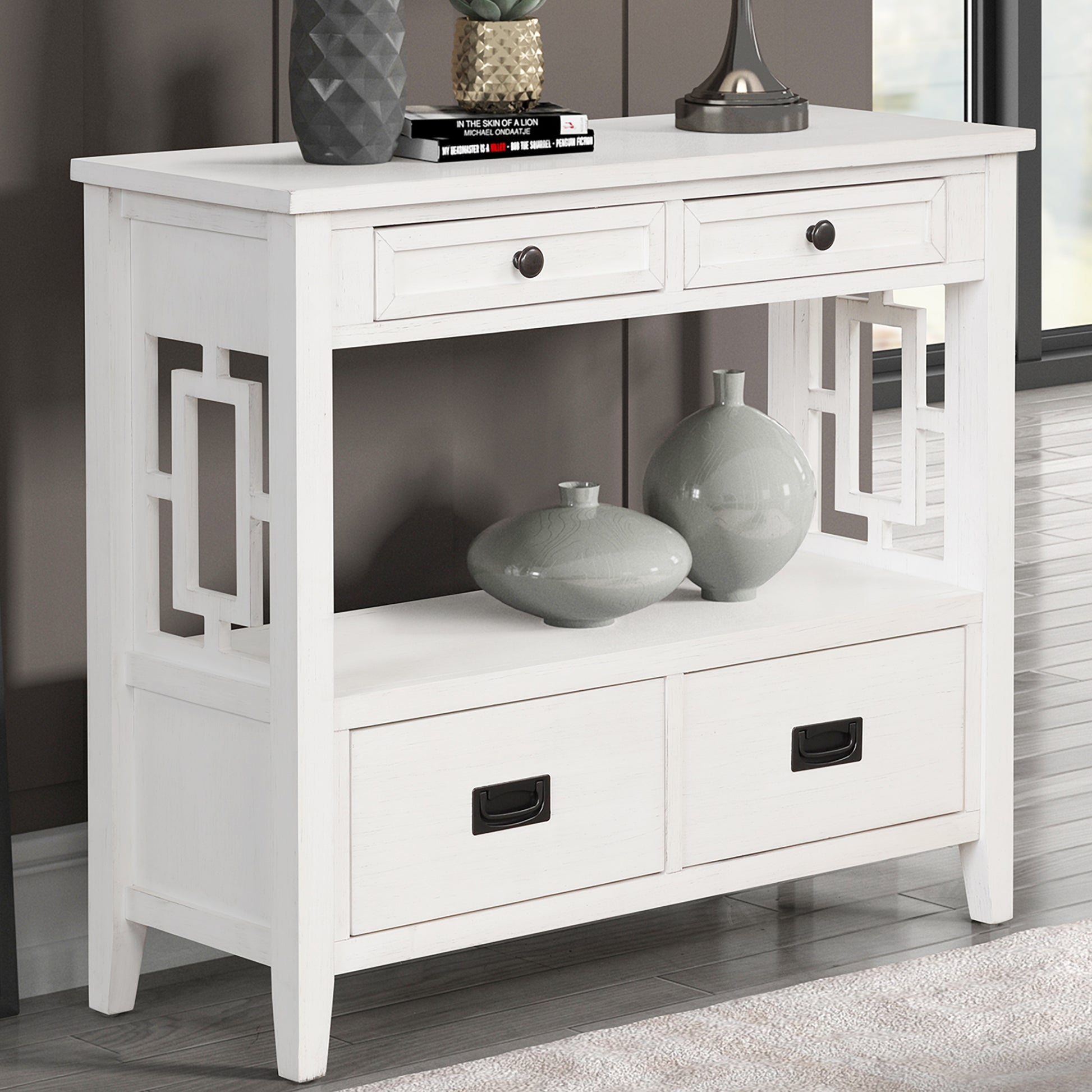 White console table with geometric cutouts and four drawers for entryway storage
