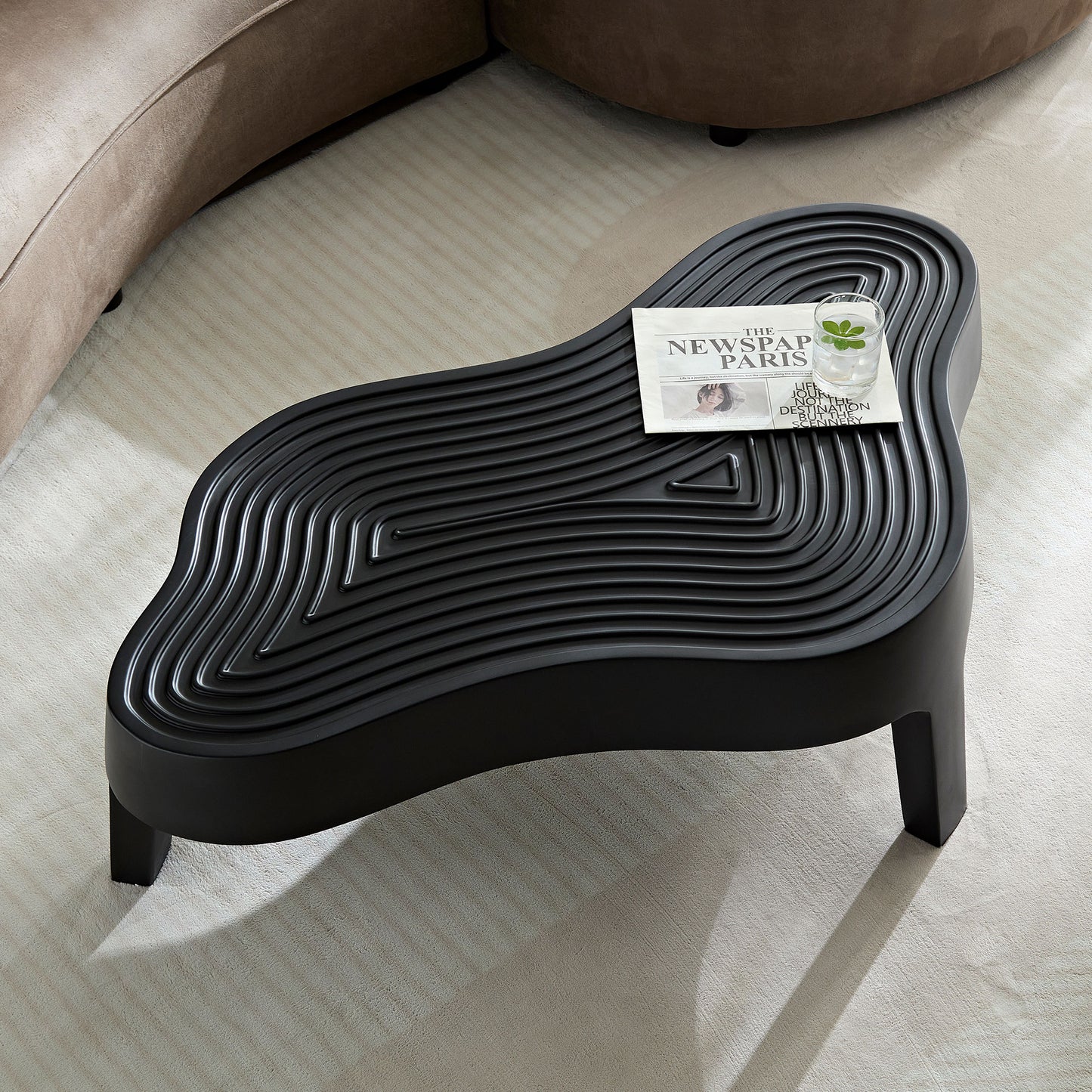 Black wavy coffee table with textured top and geometric pattern perfect for modern living rooms