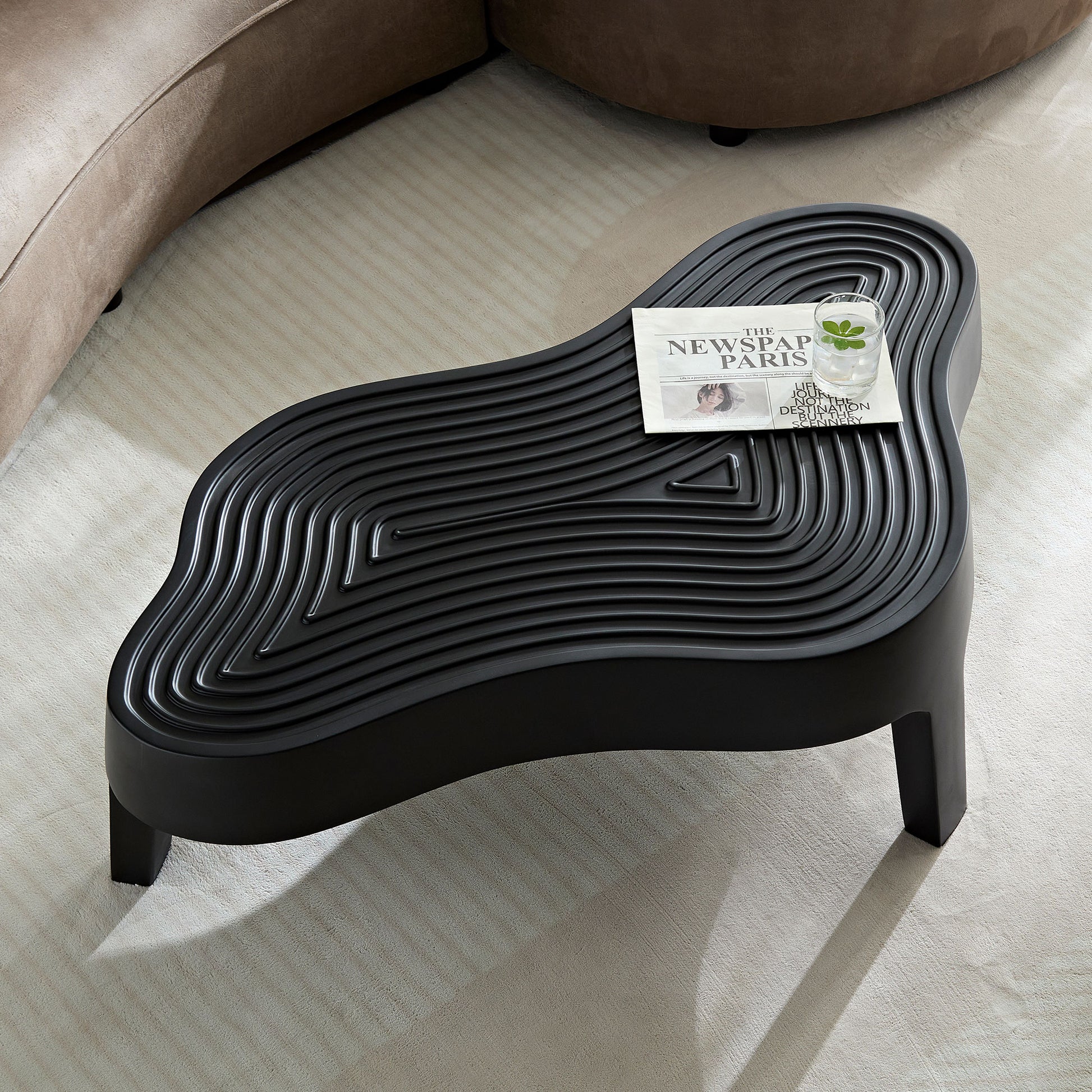 Black wavy coffee table with textured top and geometric pattern perfect for modern living rooms