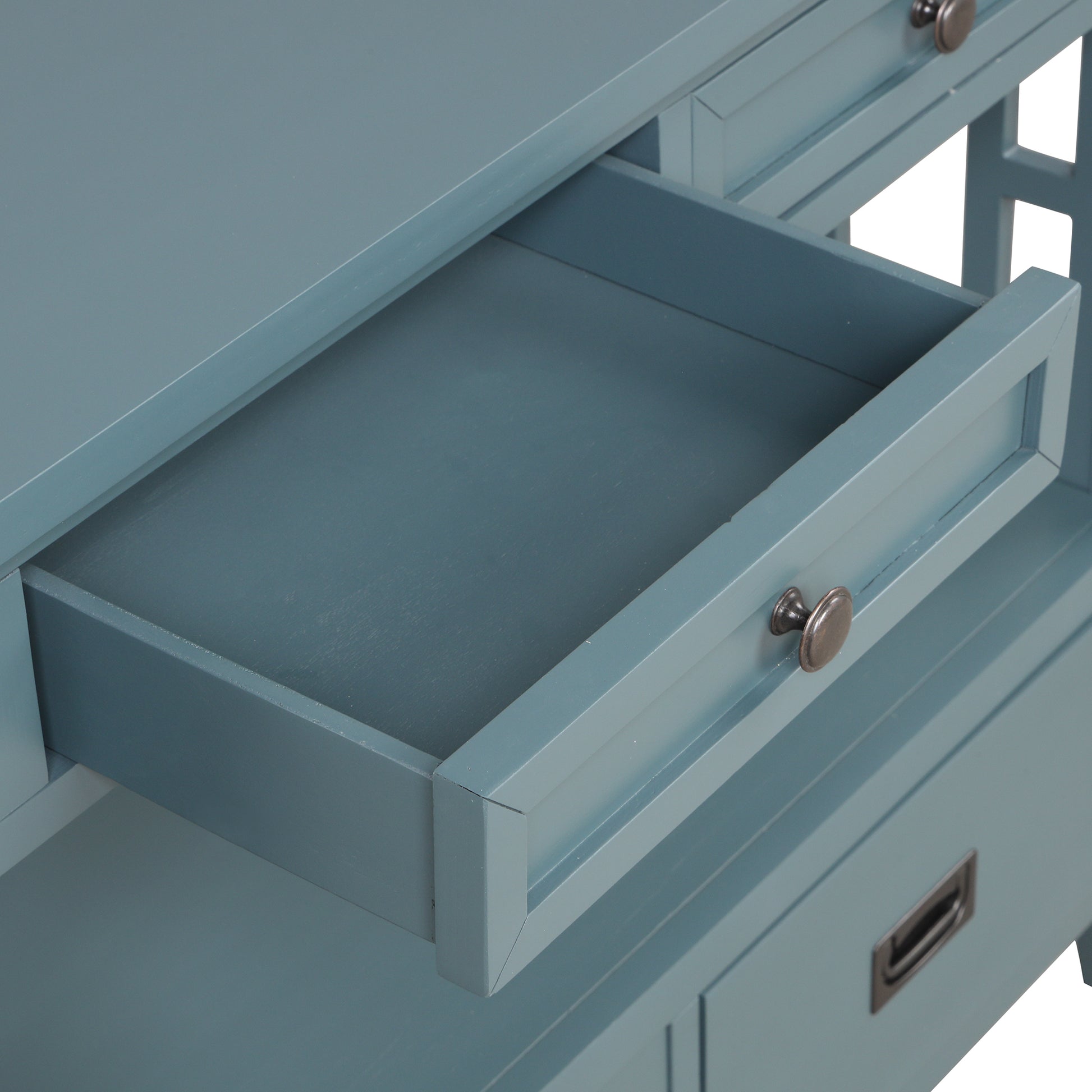 Closeup of a dusty blue wooden side table drawer showing distressed metal knob