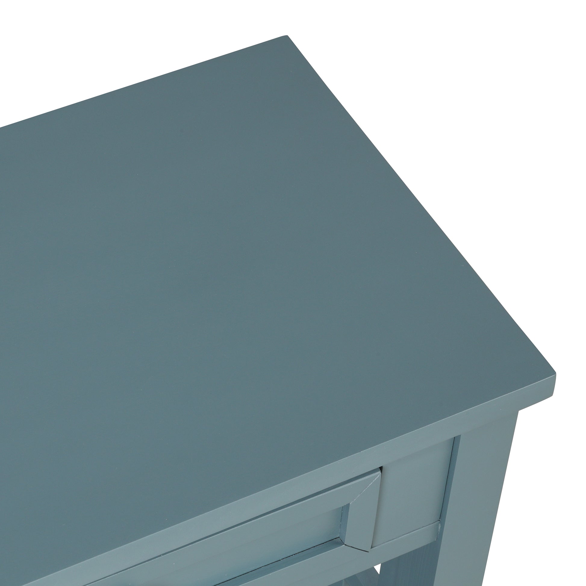 Closeup of a dusty blue console table top with a visible drawer front detail